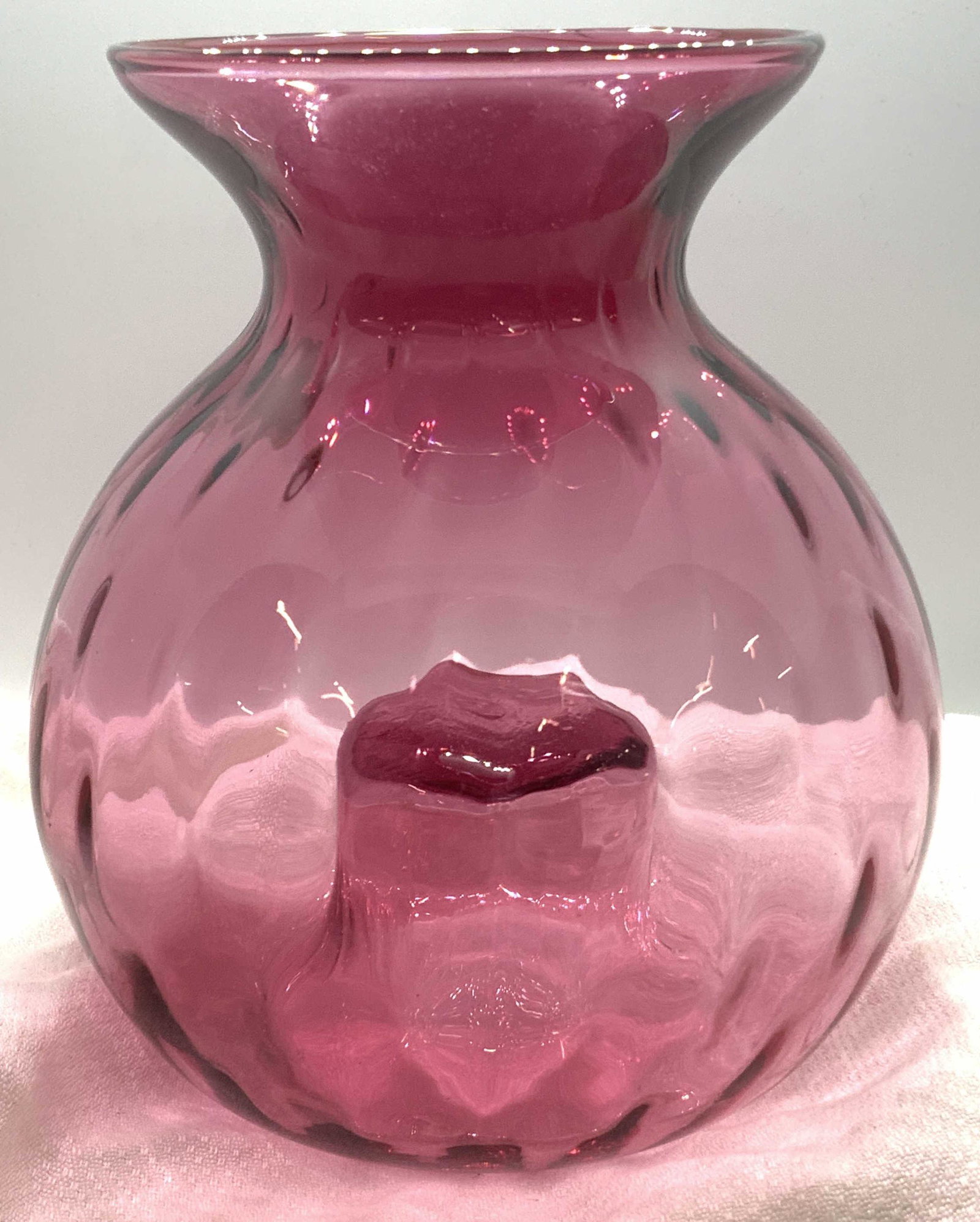 HANDMADE PILGRIM CRANBERRY Glass Vase: Translucent Cranberry glass, hand formed. Design label sticker on vase reads ‘ Pilgrim Cranberry Glass Handmade with Gold in USA’ Use for decoration or for flowers, underside created with unusual 