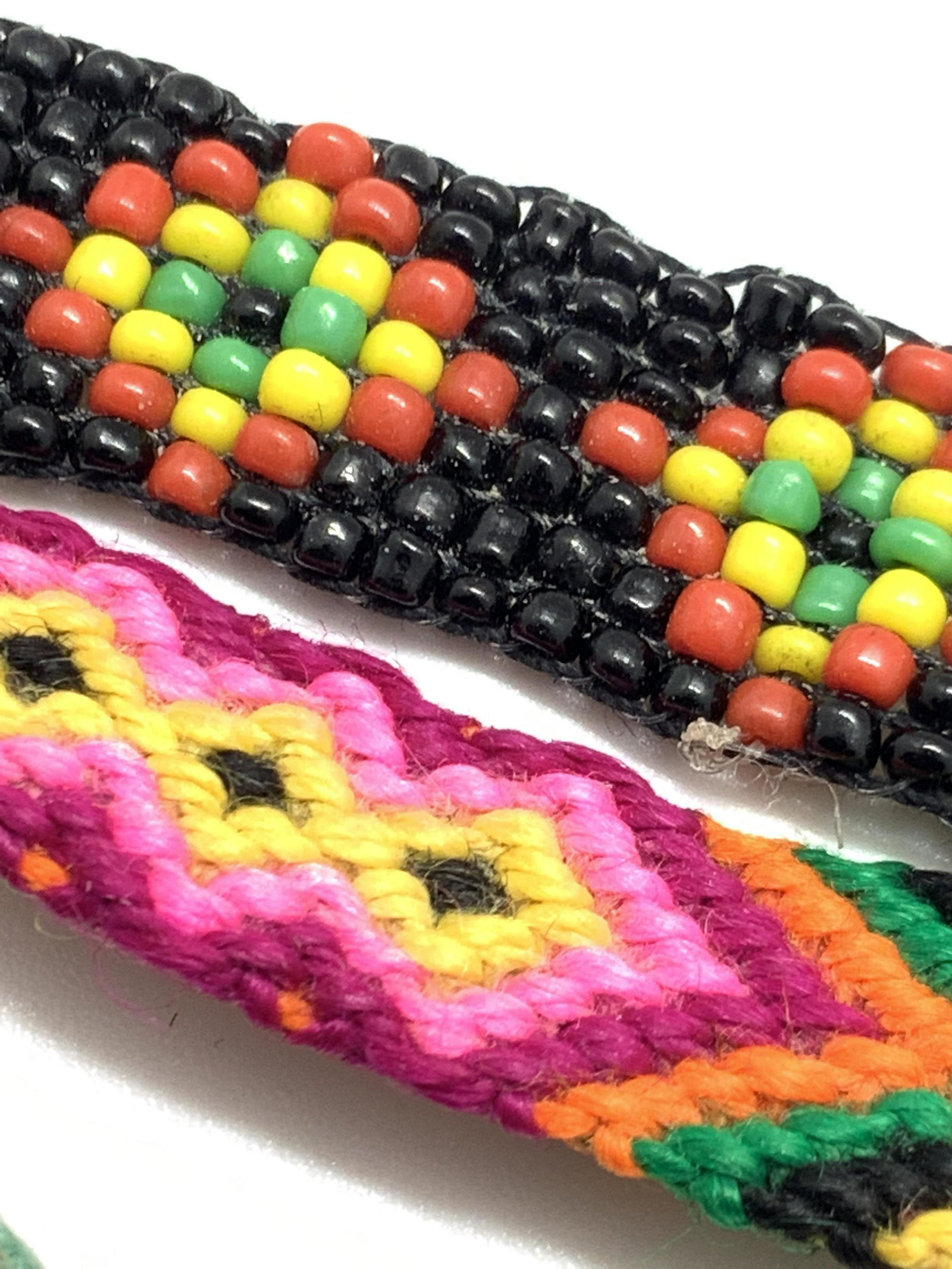 Lot 11 Handmade Arts & Crafts Fashion Jewelry: 11 pieces of handmade jewelry that includes bracelets and necklaces. Beaded strands and woven designs. Some beads have letters on them, others are metallic or wooden. Approx. Length of longest necklac