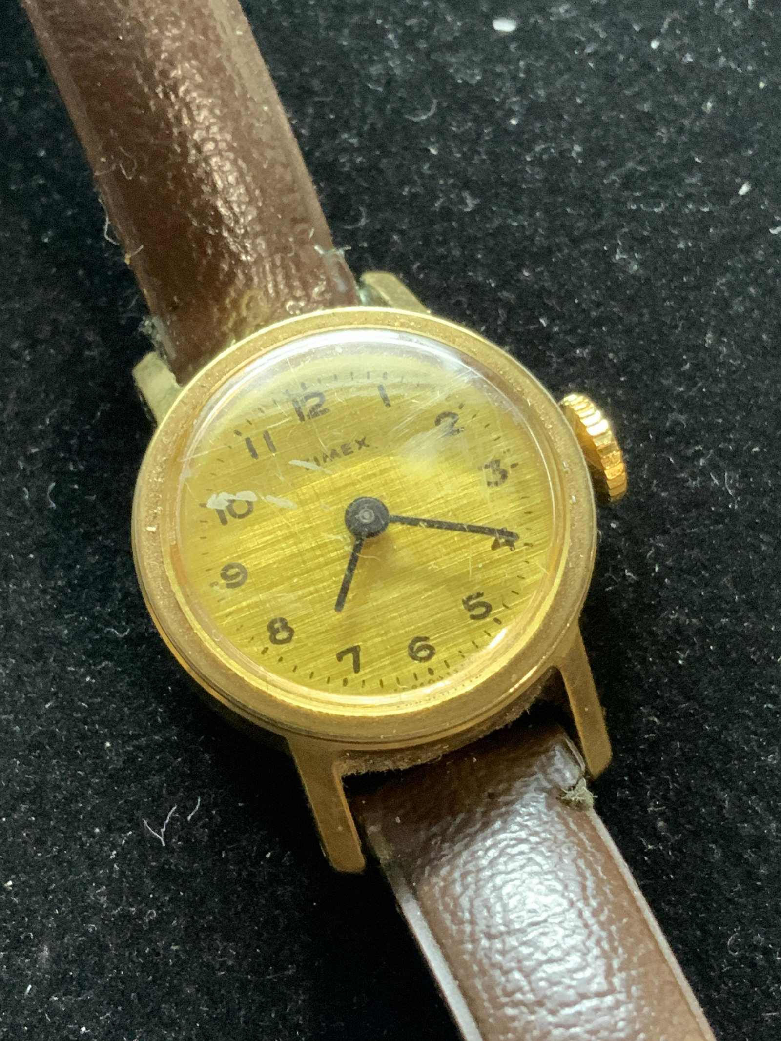 TIMEX Mid Century Ladies Wristwatch, Jewelry: Petite watch face, reads Timex, discoloration and wear to glass. Repaired leather band. 8.5 in long. Backside reads Base Metal bezel, S. Steel back. VINTAGE TIMEX WATCH , Vintage Jewelry accessory, mi