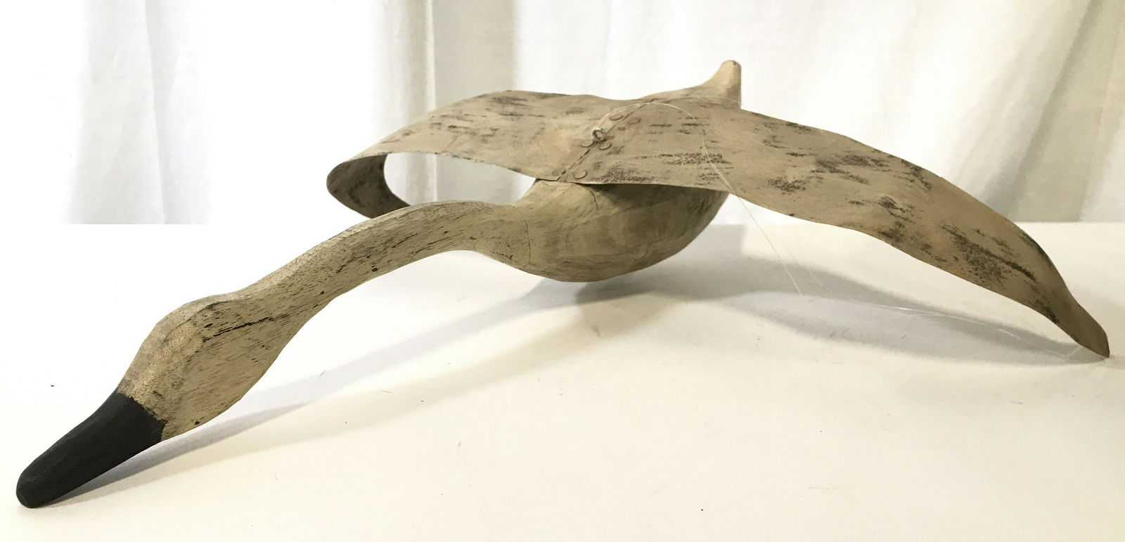 Signed Kilbride Folk Art Hanging Swan Sculpture: Signed on underside Kilbride, Vermont Folk Art. Sculpture appears to depict a swan. Piece appears to be hand crafted and hand painted. Swan body is wooden while wings are metal. Piece measures approxi