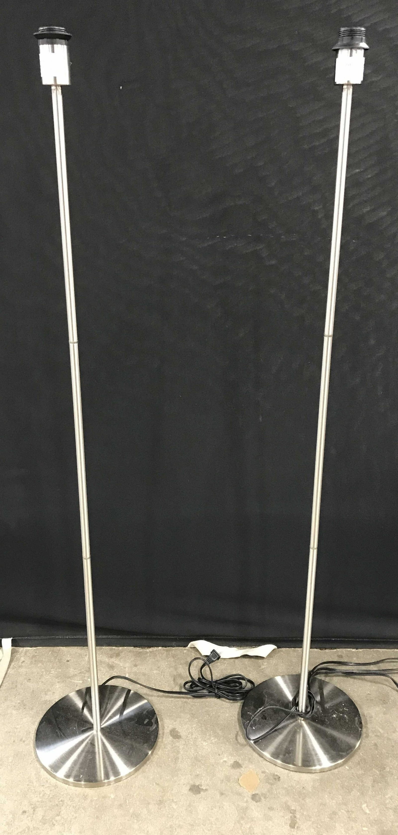 Pair Brushed Metal Floor Lamps: Pair floor lamps, brushed metal finish. Each measures approx 54 inches H, and 10 inches in diameter. Wear is consistent with age and use. Lamps, lights, lighting, home decor, vintage decor, home light