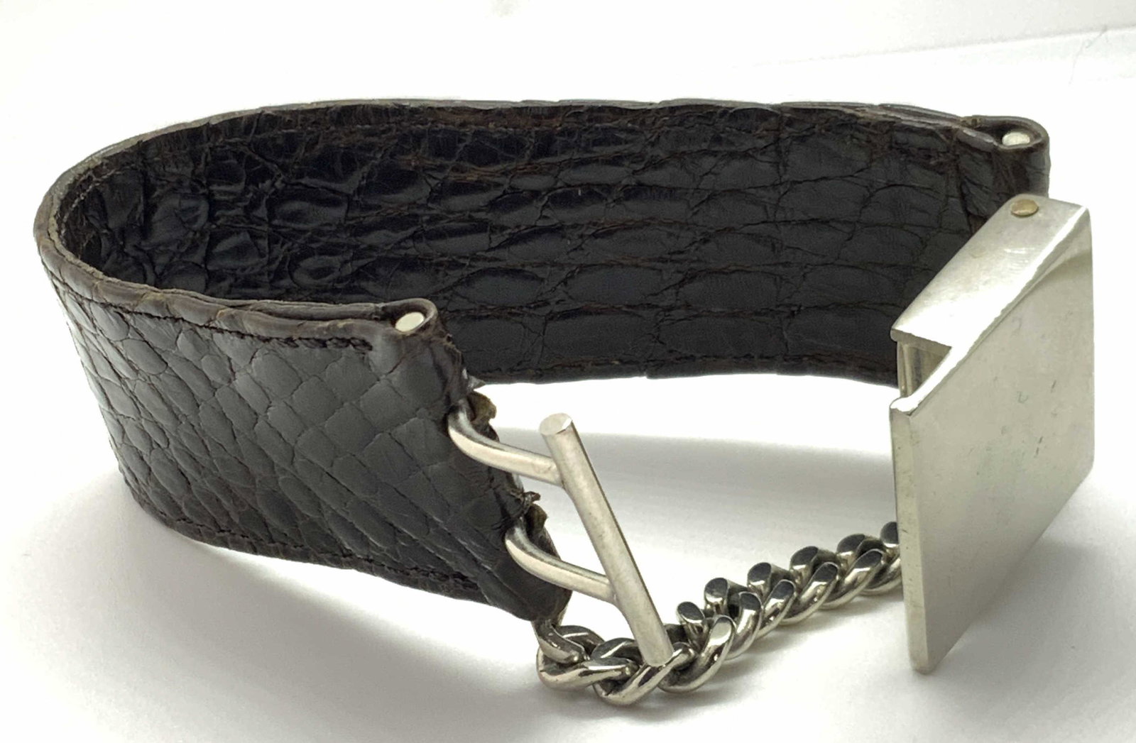 Vintg. Faux Snakeskin Buckle Bracelet, Jewelry: A brown faux snakeskin bracelet with a silver tone buckle clasp. Curb chain accent. Up cycle, new clasp. Approx. Length 7 in. Approx. Width 1.25 in. Property of Paris, France Estate Vintage bracelet, 