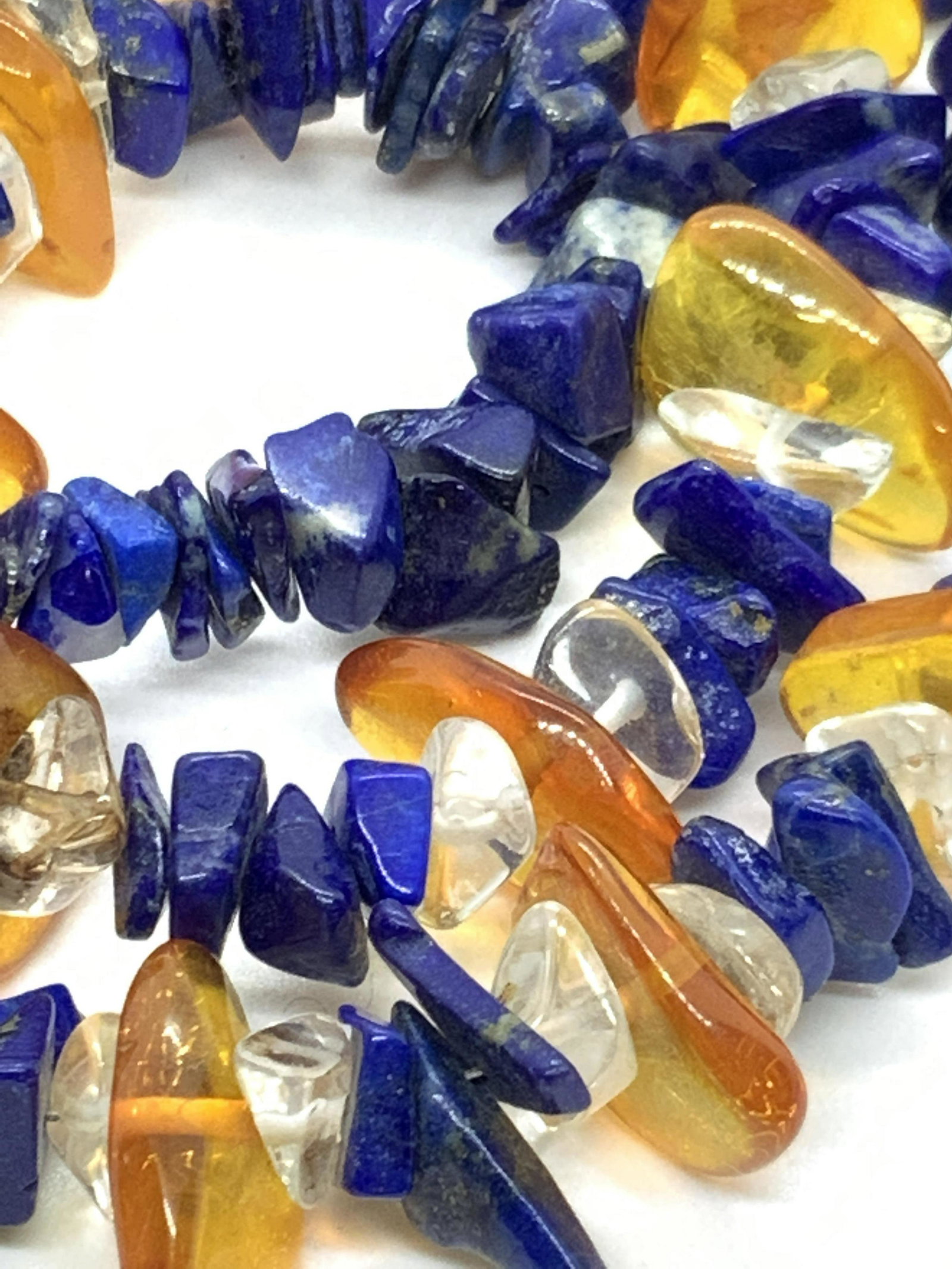 Natural Stone Necklace, Lapis Lazuli & Quartz: A natural stone necklace featuring lapis lazuli, clear quartz , and amber stone shards. Each piece is a unique size and shape. Approx. 18 in. Length. Largest piece of amber approx. .75 x .75 in. Silve