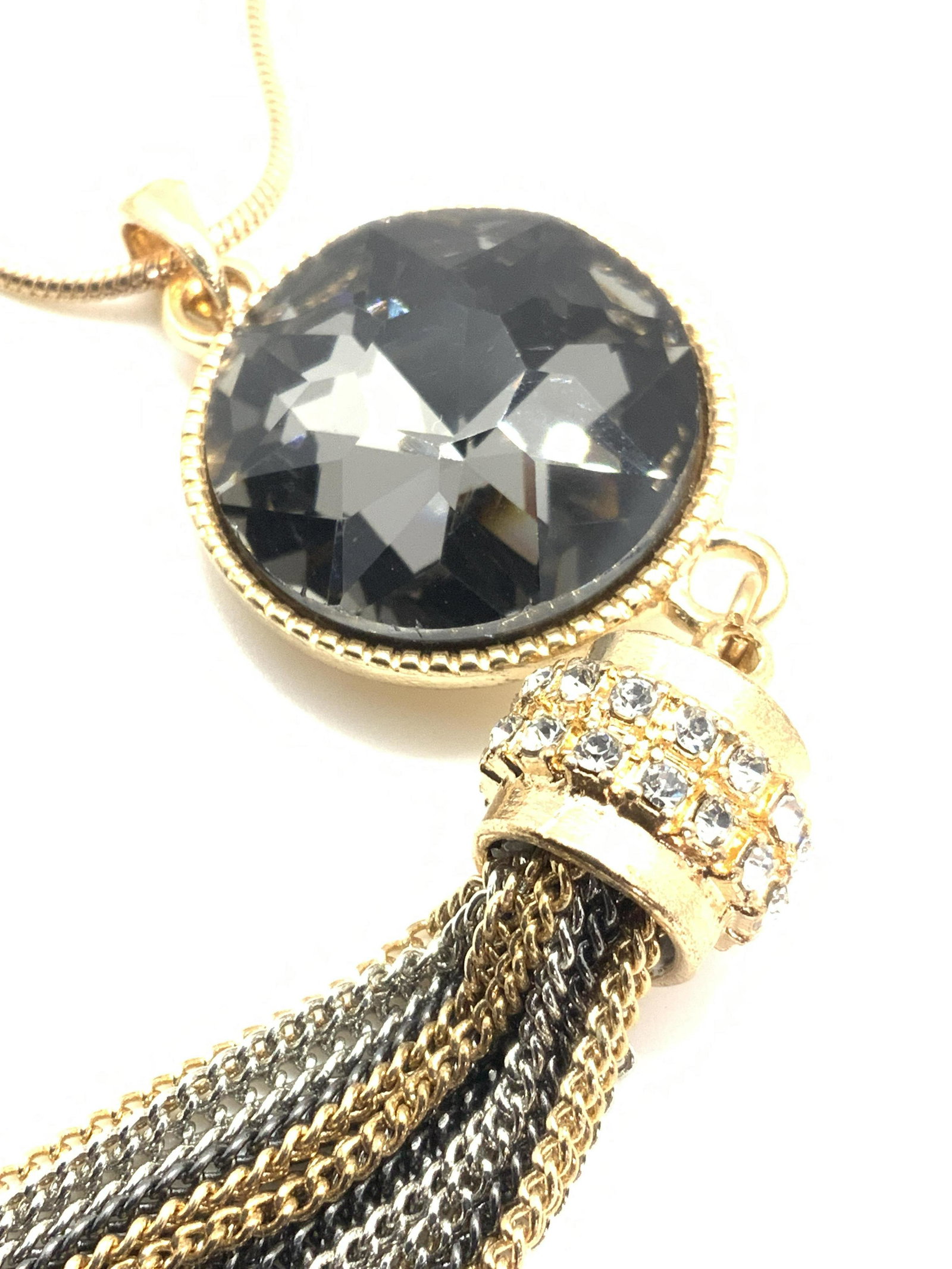 Multi chain Tassel Fashion Pendant Necklace: modern piece, gold tone snake chain with long pendant consisting of faceted smoky Quartz crystal, bezel set , connected to crystal accessory with multi color metal chain tassels. Total pendant length 
