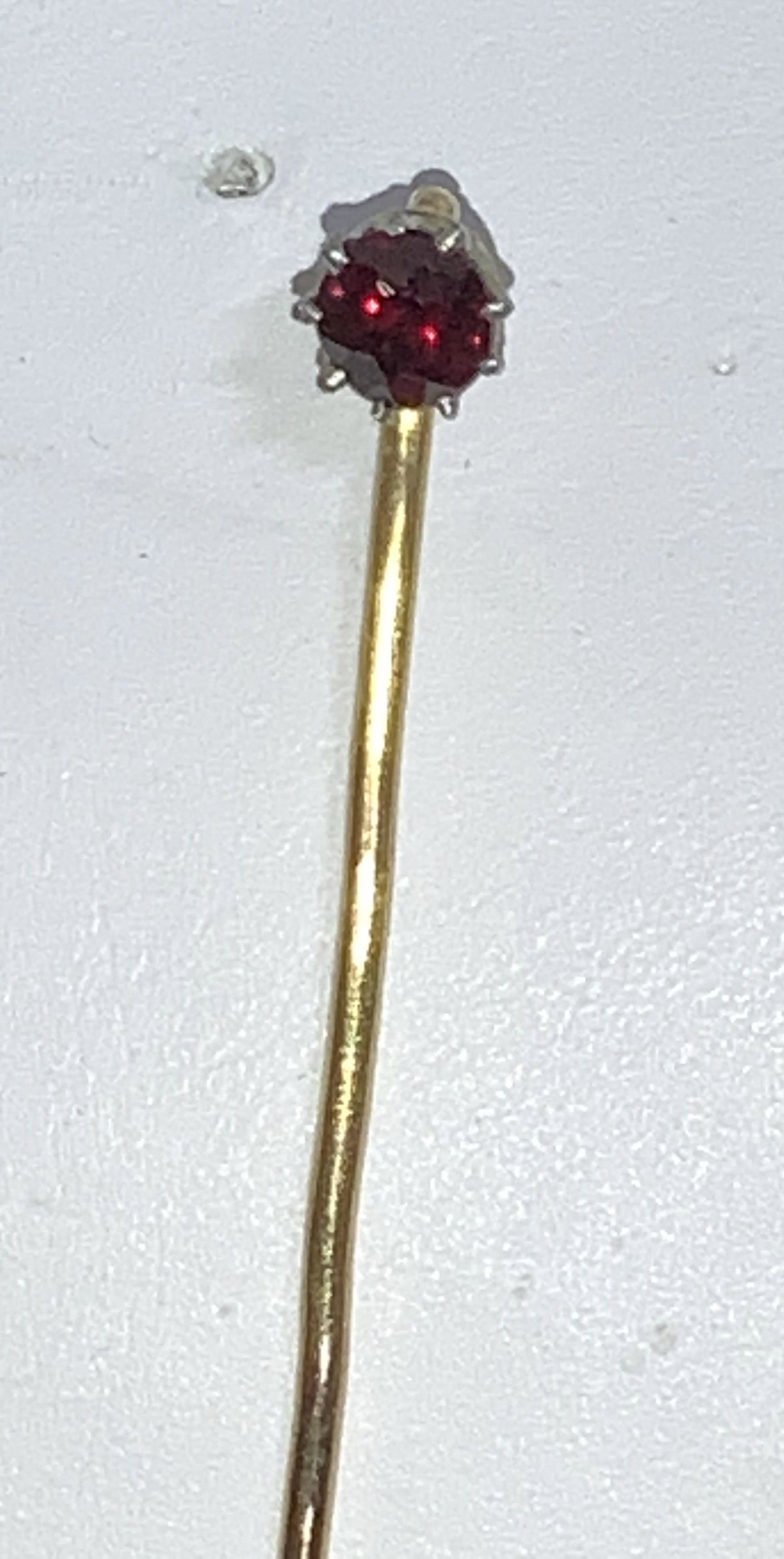 14 K GARNET ANTIQUE Arts & Crafts Era Pin: A bespoke antique piece with a solitaire 4 mm garnet in 9 prong setting. Pin 14 K gold, tested with puriTEST. most antique jewelry was not marked Pin length 2.5 in. 1.6 g total weight. Garnet tests po
