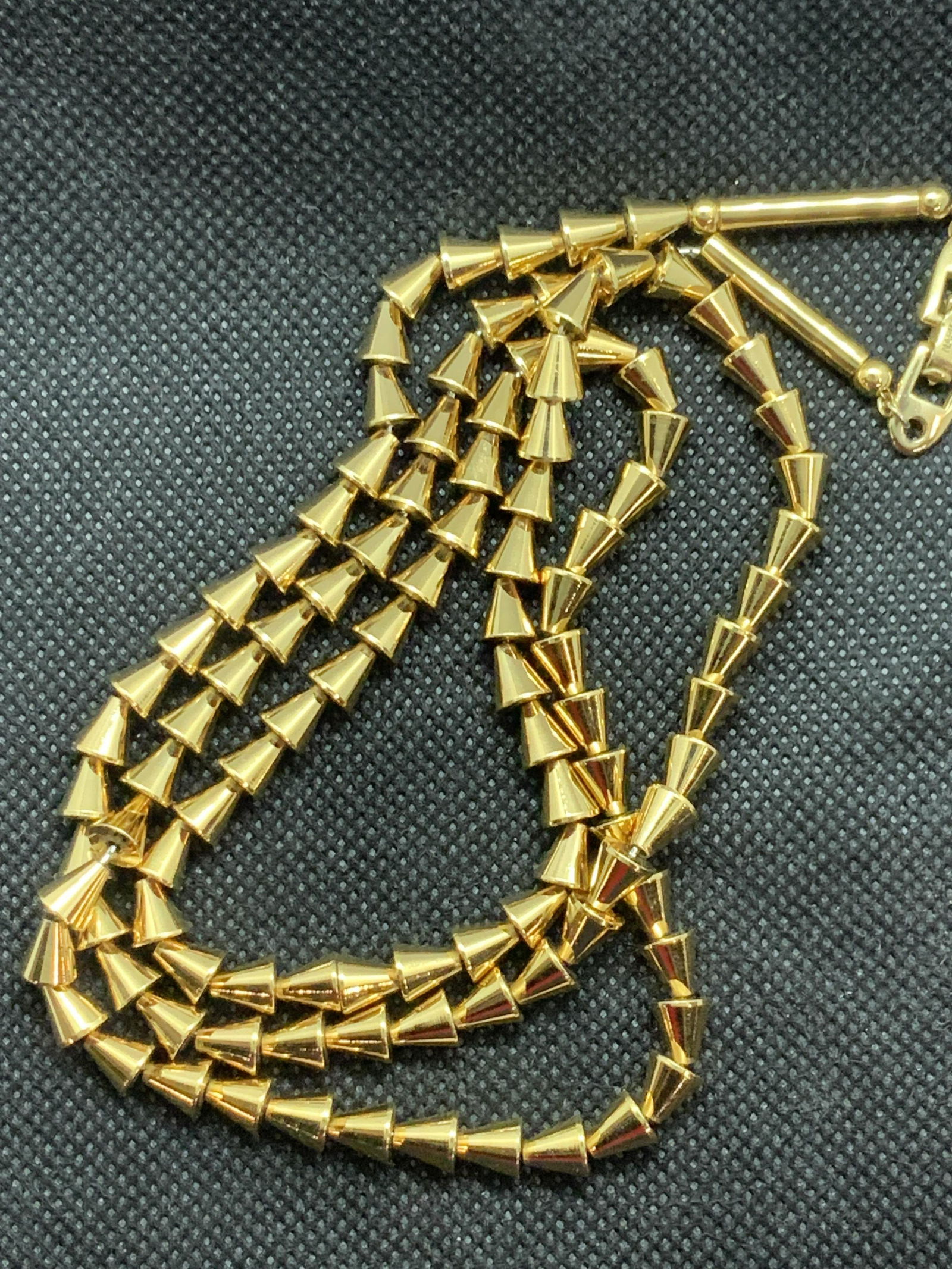 NAPIER Hallmarked Gold Tn Triangle Bead Necklace: Weighted metal necklace in gold tone, signed Napier on box clasp and copyrighted. 28 in. Length with a slight Egyptian style. Designer Brand Jewelry, Napier Necklace, Napier Gold Tone Triangle Bead Ne