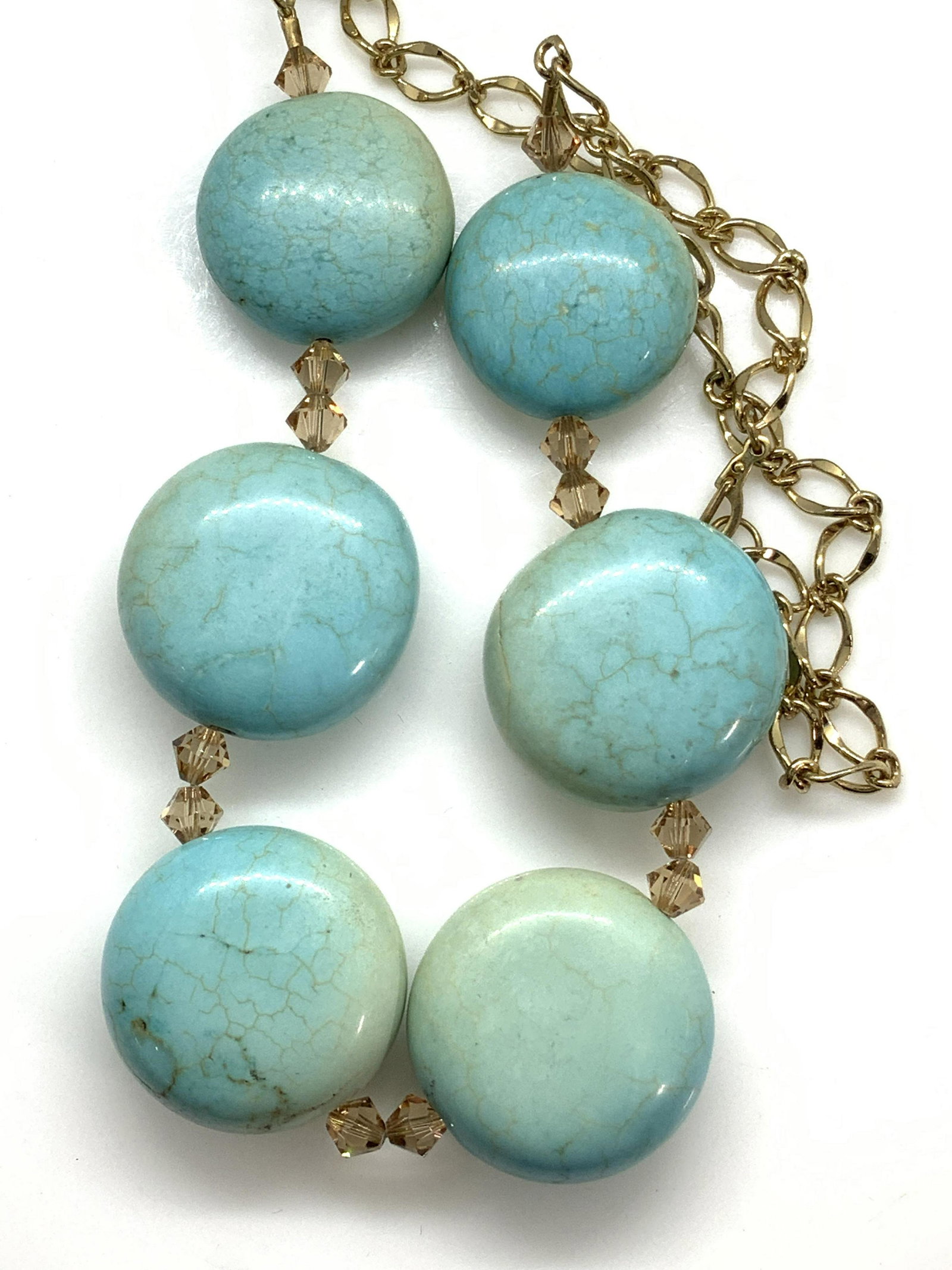 Chunky Turquoise Stone Collar Necklace, Jewelry: Polished cabochon turquoise stone with thin vein matrix. Stones are oversized and weighted, app 1 in diameter by 3/8 in. thick. 6 stones separated by AB diamond shape crystal beads, shiny gold tone ch
