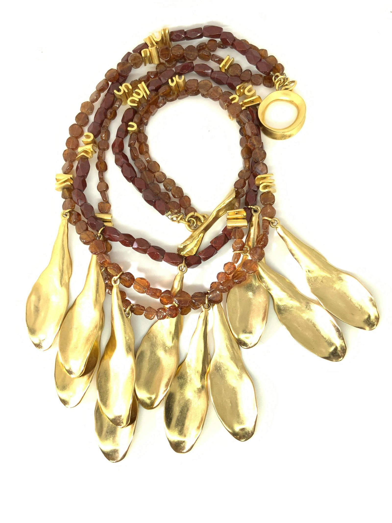 RLM Vtg Designer Gold Plated Jasper Petal Necklace: A vintage necklace crafted by RLM STUDIOS ( Robert Lee Morris ). This piece features gold plated dangling petal forms and gold plated beads throughout. The beads are intersperse between natural jasper