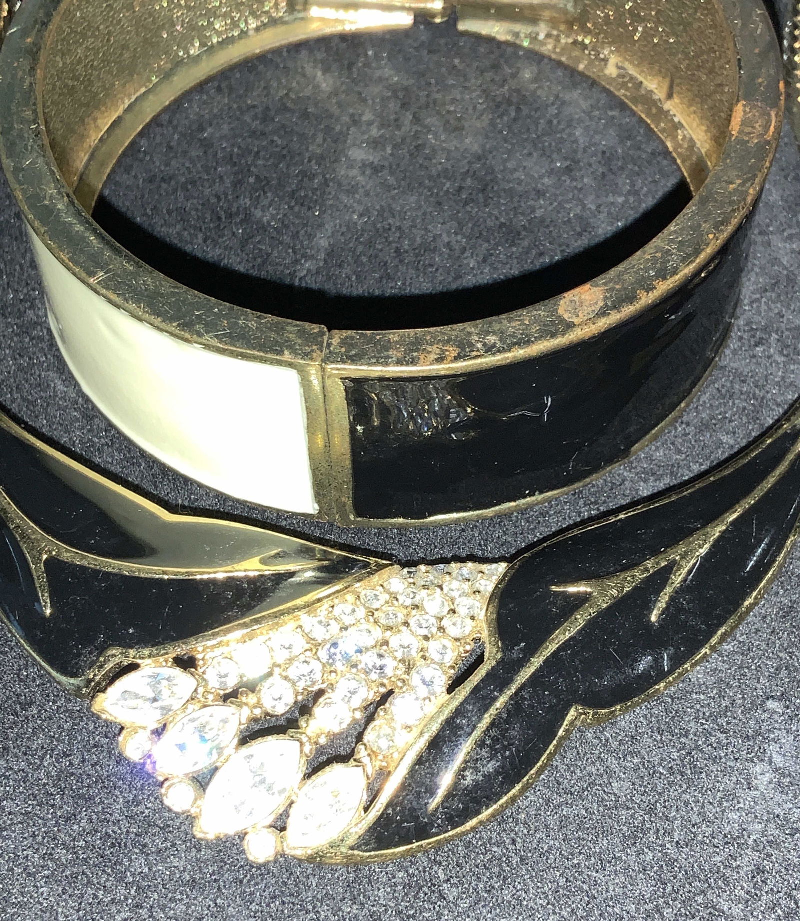 Set 2 TRIFARI Vintage Art Deco Enamel Jewelry: Set 2 Enamel Black/ white bangle bracelet and SIGNED TRIFARI Enamel & Crystal pendant bib style necklace on bone chain, 14.5 in. All in gold tone metal. Bangle on a hinge and closes shut with tension.