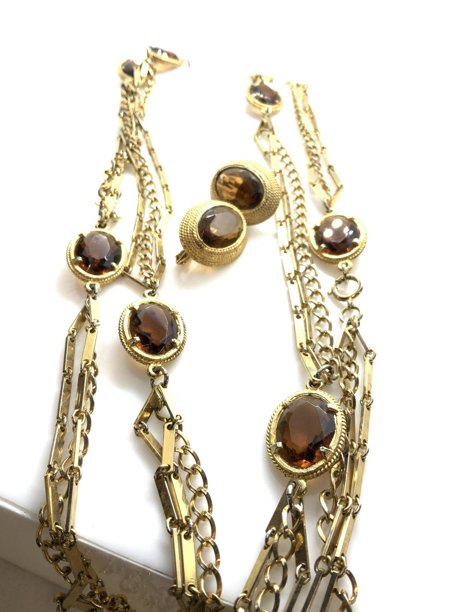CHANEL style Jewelry Set 2, Lng Chain + Earrings: EMMONS Designer Jewelry, hallmarked on clip on earrings, center faceted amber colored stone with etched rope style halo. Long multi strand chain, 57 in., Coordinates with earrings, faceted amber color