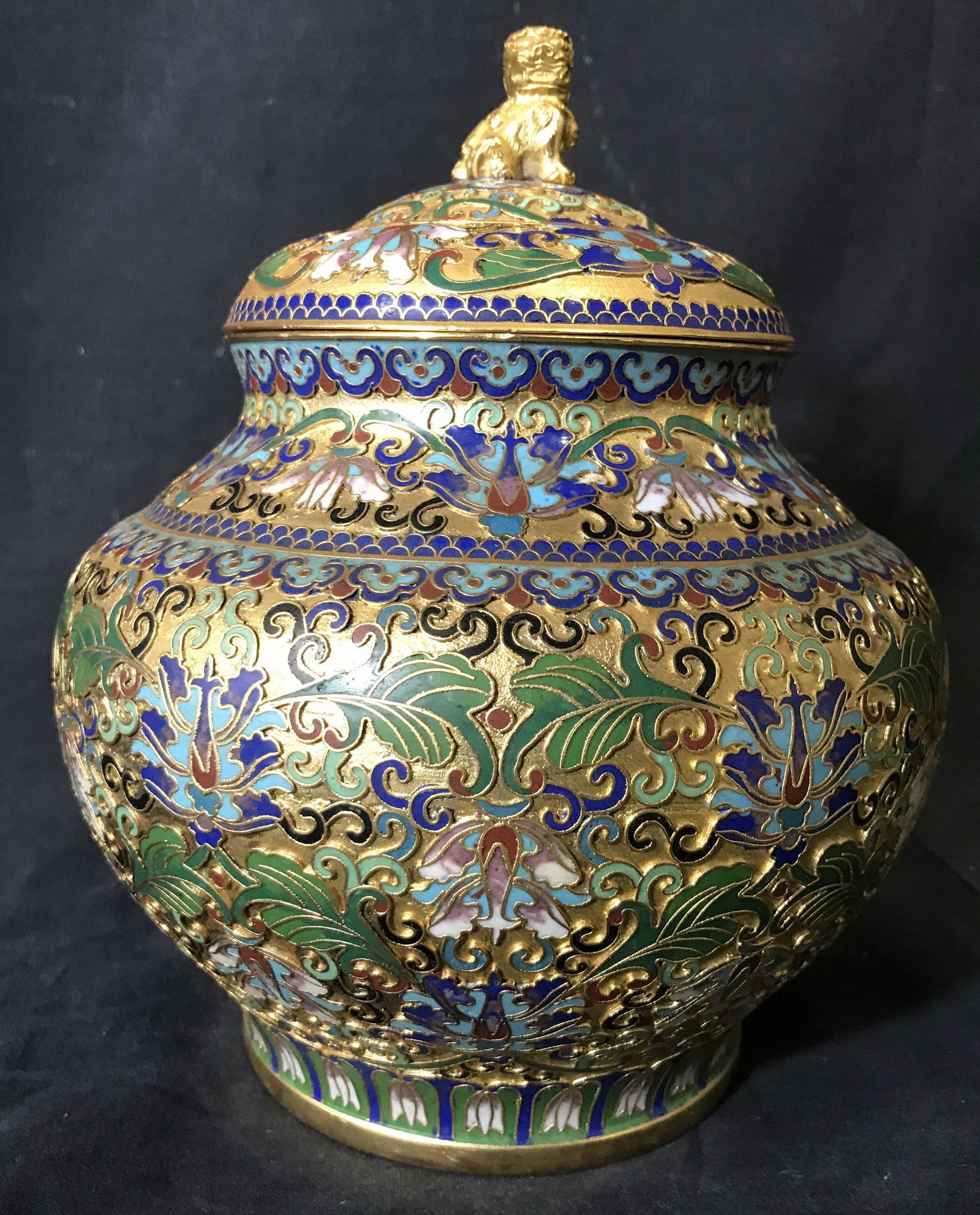 Vintage Asian Gilded Cloisonné Urn Ginger Jar: Vintage Asian cloisonné urn. ginger jar Some cavities colored with gilt paint, decorated with multi toned floral and leaf like pattern. Interior and underside are turquoise. Finial on lid is a gilded