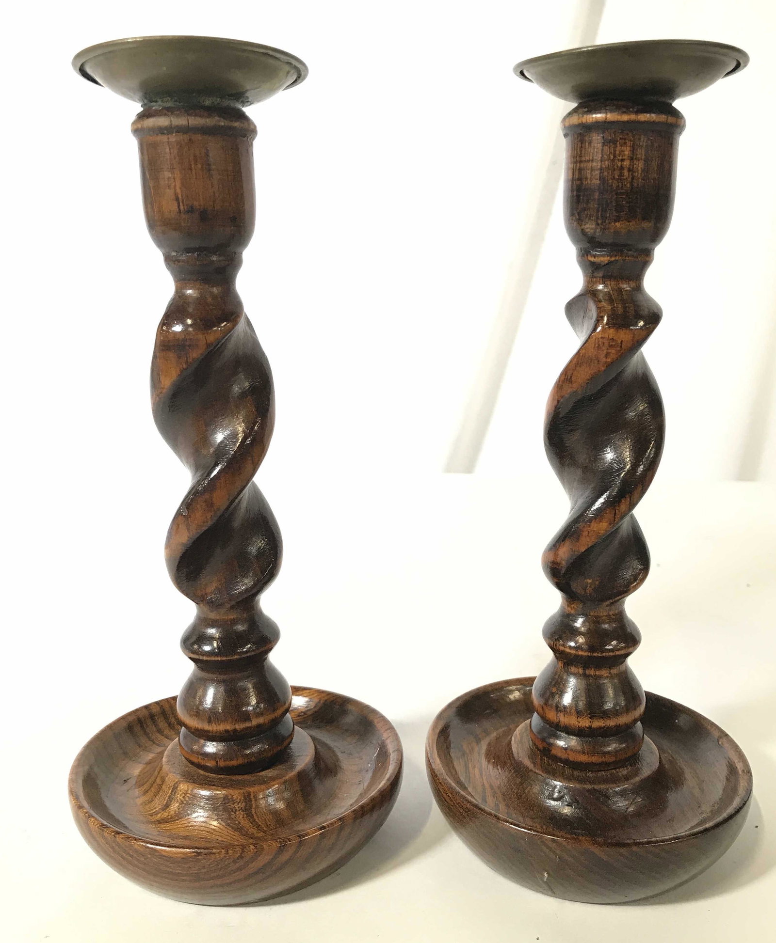 Pair Vintage English Oak Barley Twist Candlesticks: Candlesticks are vintage possibly antique. Each are English oak. Candlesticks have barley twist structures. Each have gold toned metal Bobeches, possibly brass. Each piece measures approximately 8.5 i