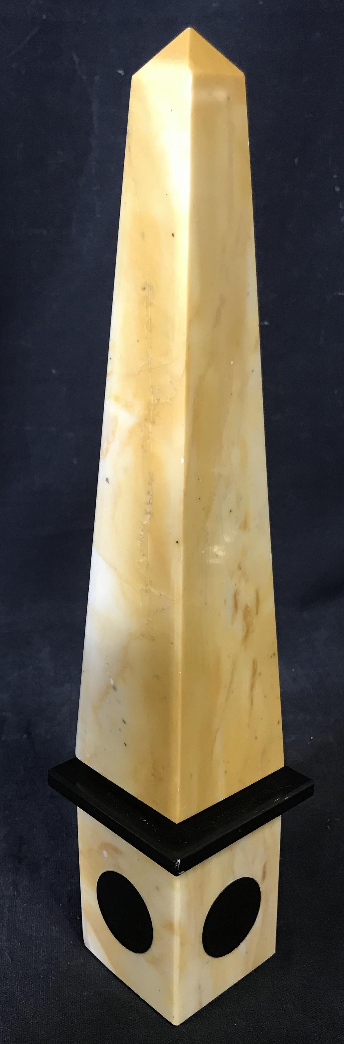 Carved Marble Desk Size Obelisk Ornament: Carved stone obelisk. Measures approx 11.25 inches H, and 2.5 inches W. Caramel toned w black accents. Wear is consistent with age. Desk accessory, shelf accessory, carved stone, carved marble, mantle