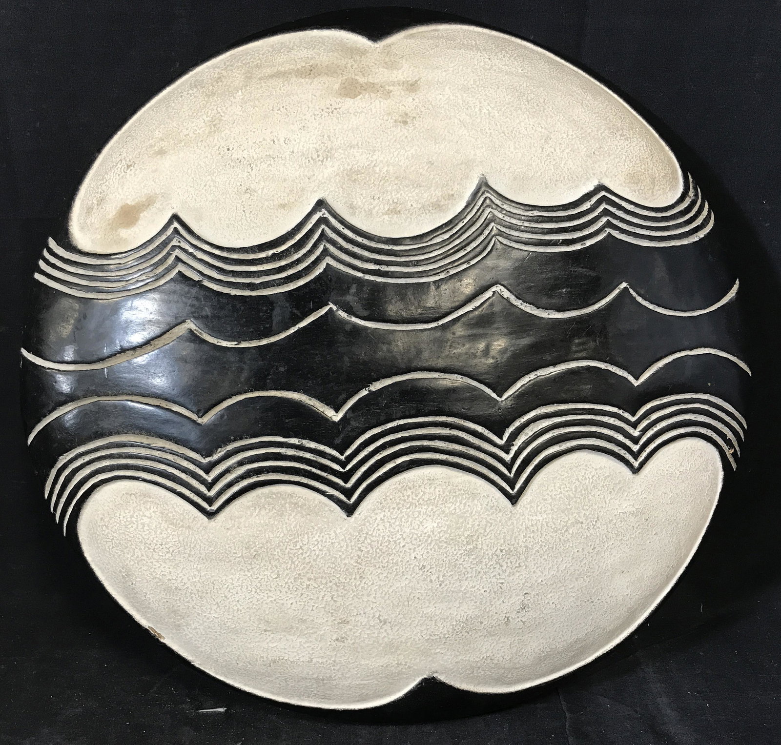 Traditional South African Tribal Shield: Traditional South African Tribal Shield, origins can be found in South Africa, wooden shield with black and white paint with a wave pattern carved into the front, handle carved into the back, diameter