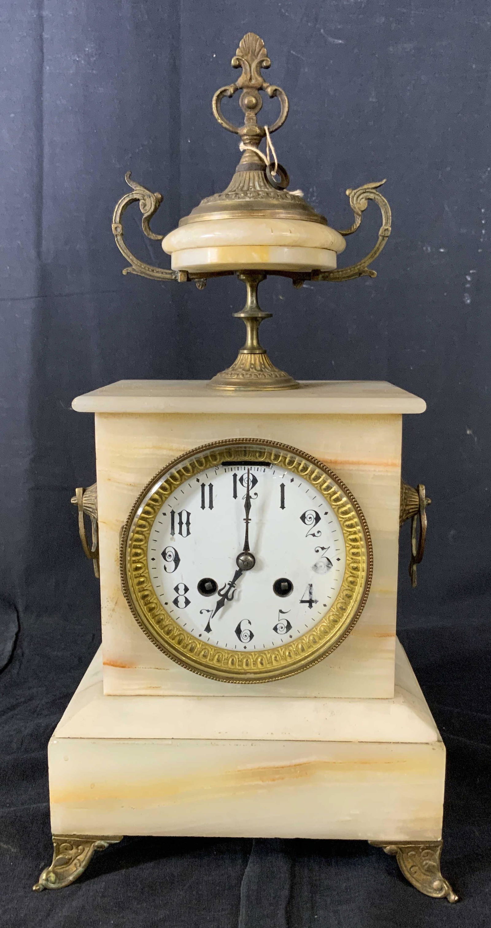Antique French Marble Gilt Mantle Clock: Vintage possibly antique French mantle clock, Marked on brass back hinges closure France, marble mantle clock with gold toned metal feet, side rings and tiered finial, not tested for working condition