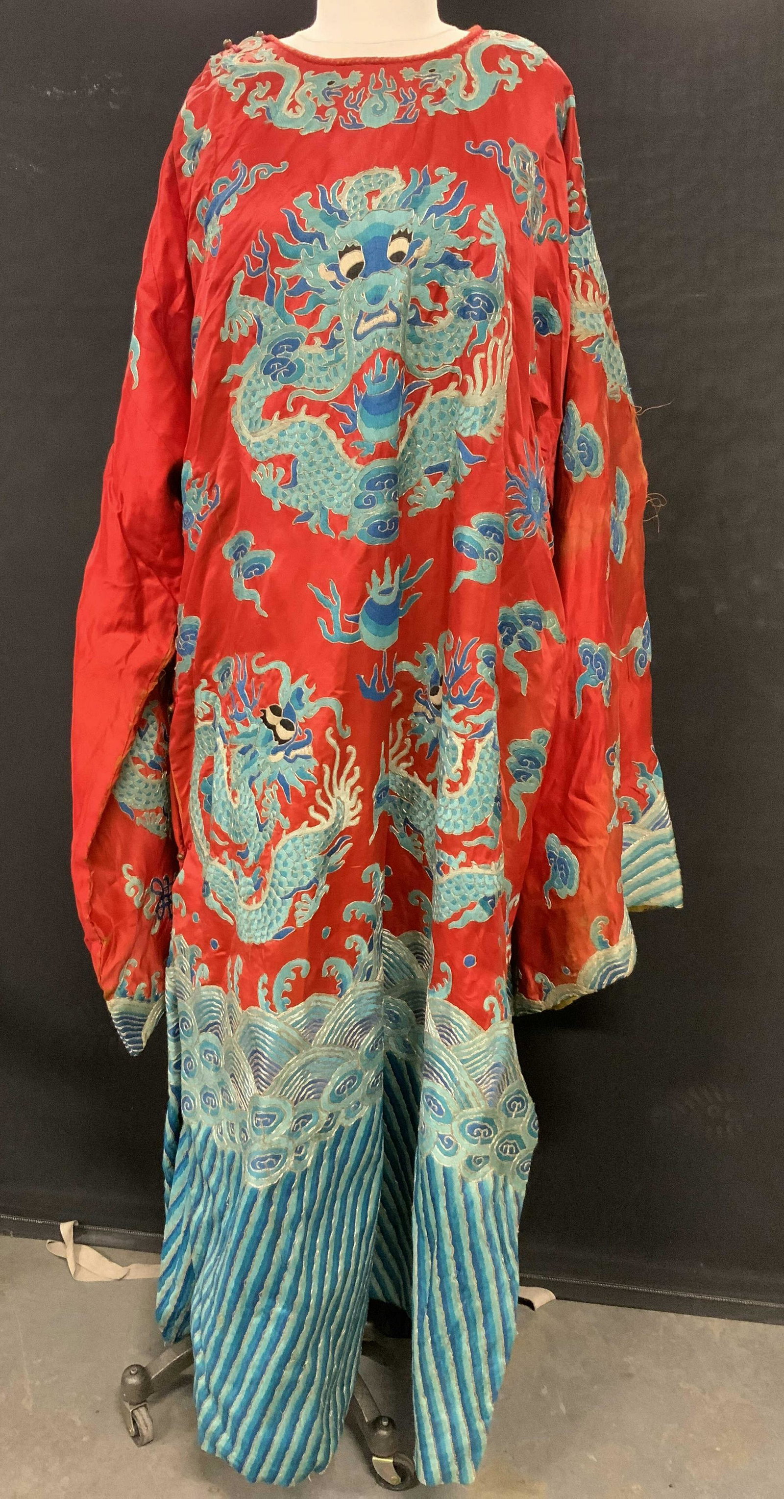 Vintage Red Chinese Style Embroidered Court Robe: Red Chinese Style Embroidered Court Robe, no apparent inscriptions or labels, interior likely line, exterior possibly satin or silk, measures 54 1/4 inches long, sleeves measure 34 inches long, one si