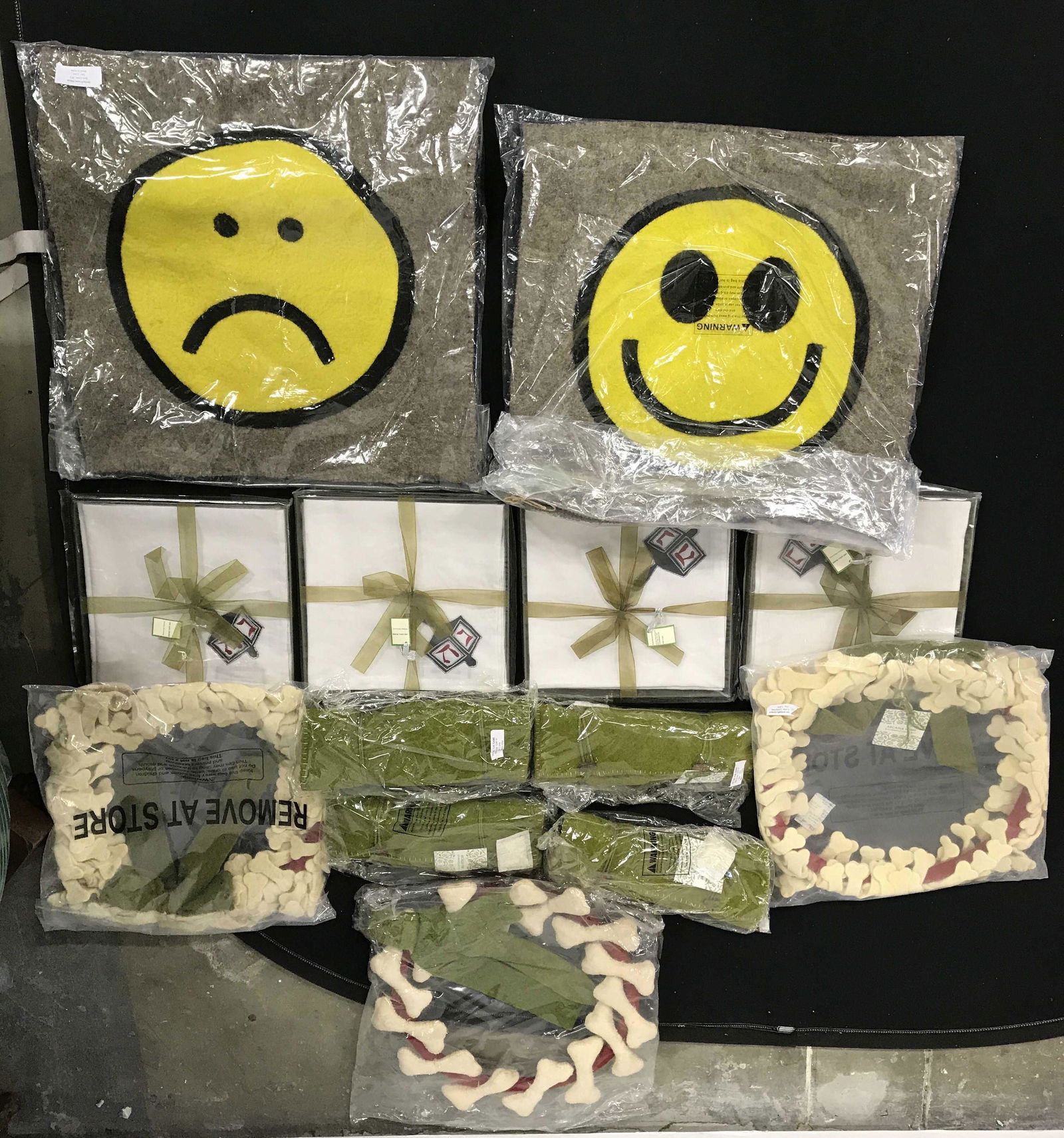 Lot 13 Group New Merchandise Donated From Mma: Lot includes 4 tic tac toe games, 3 dog bone style wreaths, 4 Judaica napkins & 2 Smile/Frown pillows. Wreaths measure approximately 13 inches wide. Group lot of new and packaged merchandise donated b