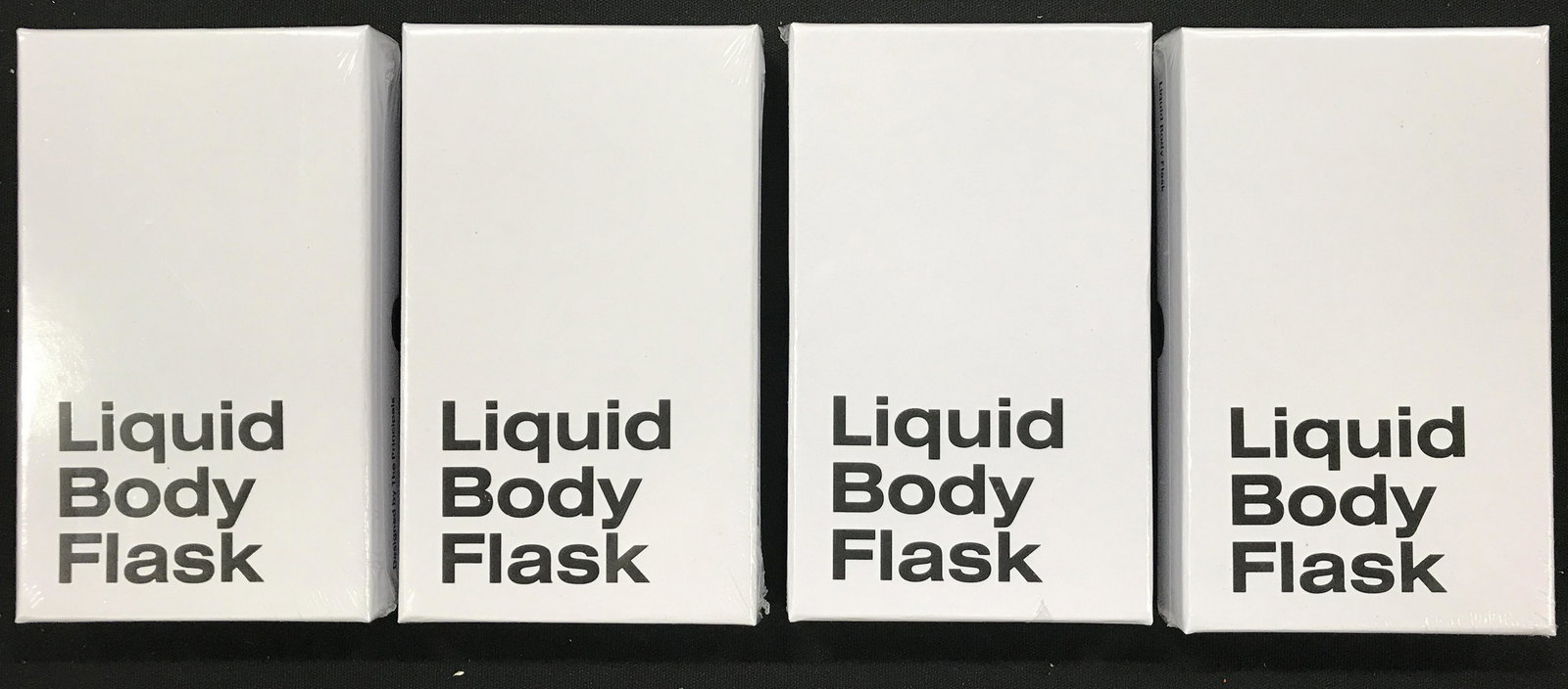 Lot 12 AREAWARE Liquid Body Flasks: Lot includes 12 flasks each marked for AREAWARE. Each flask comes in original box. Each measures approximately 6.5 inches tall 4.5 inches wide. group lot of new and packaged merchandise donated by mma