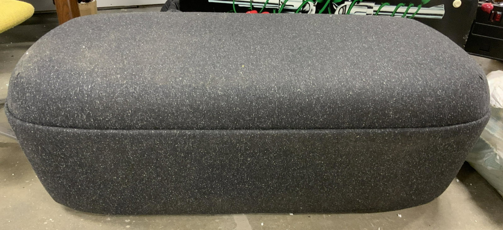 STUDIO TK CESTO Bench Ottoman on Castors: Upholstered CESTO BENCH by STUDIO TK. UPHOLSTERY IS ash toned. Measures approx 17.75 inches H, 51.5 inches W, and 25.25 inches deep. Base is plastic and on wheels. Wear is consistent with age and use.