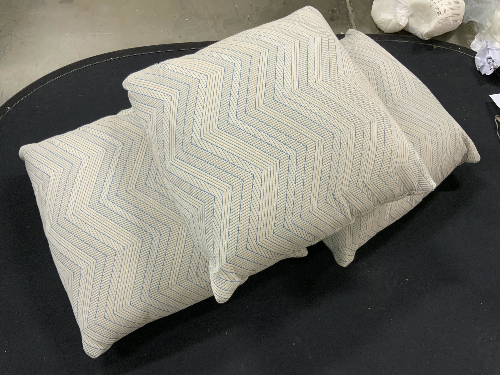 Set 3 Zig Zag Patterned Throw Pillows: Lot includes 3 throw pillows. Each are light sand toned with blue stripe and Zig zag pattern detail. Each measures approximately 23 inches square. Proceeds will be donated to DIFFA in NYC. Pillows, th