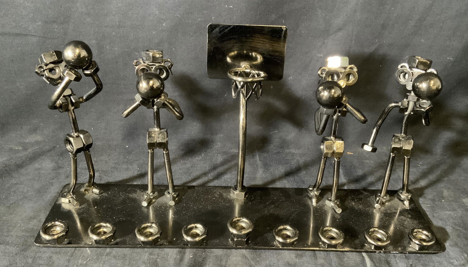 Hand Crafted Basketball Figural Menorah: Menorah hand crafted basketball figural theme, sticker residue to the underside, subject a handcrafted menorah made of metal pieces such as nuts and bolts, front of piece shows the 9 placements for th