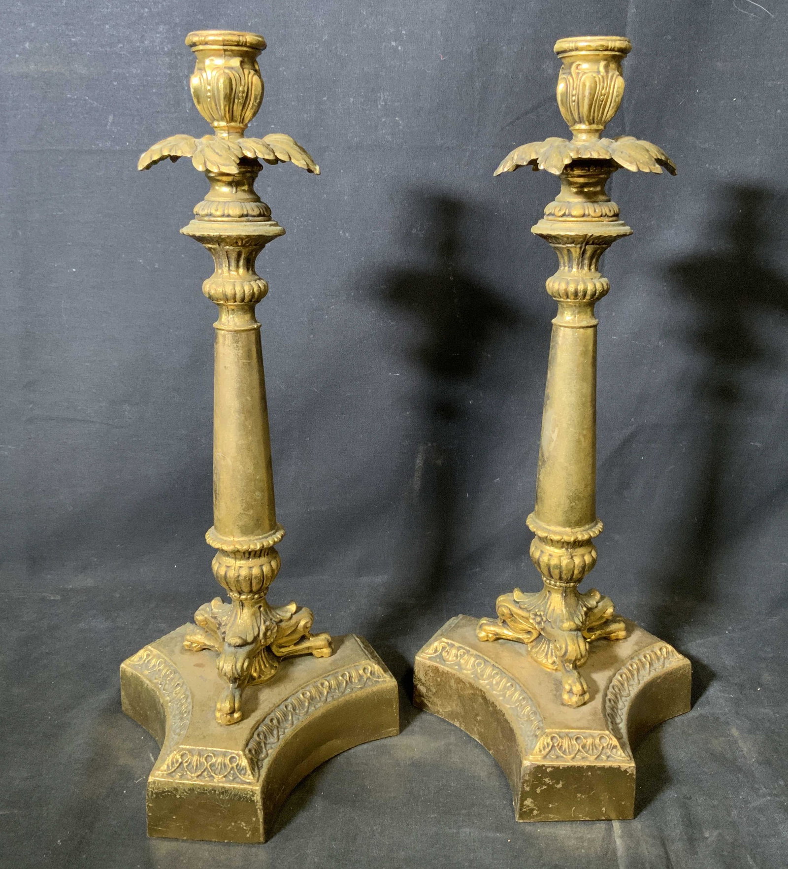 Pair Antique Gilded Metal Candle Sticks: Pair antique gilded metal candle holders, pair made in a a baroque rococo style, body of candle holders can be unscrewed from base, both measure 15.5 inches at tallest point, both have green felt to t