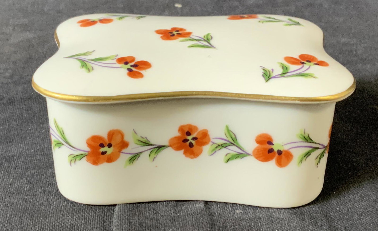 TIFFANY & CO LIMOGES Porcelain Trinket Box: TIFFANY & CO LIMOGES Porcelain Trinket Box, stamp to base reads ‘Tiffany & Co Limoges France Tiffany 8 Poppies GDA Limoges France’, floral design, measures 1 5/8 x 3 1/2 inches at widest point, Ti