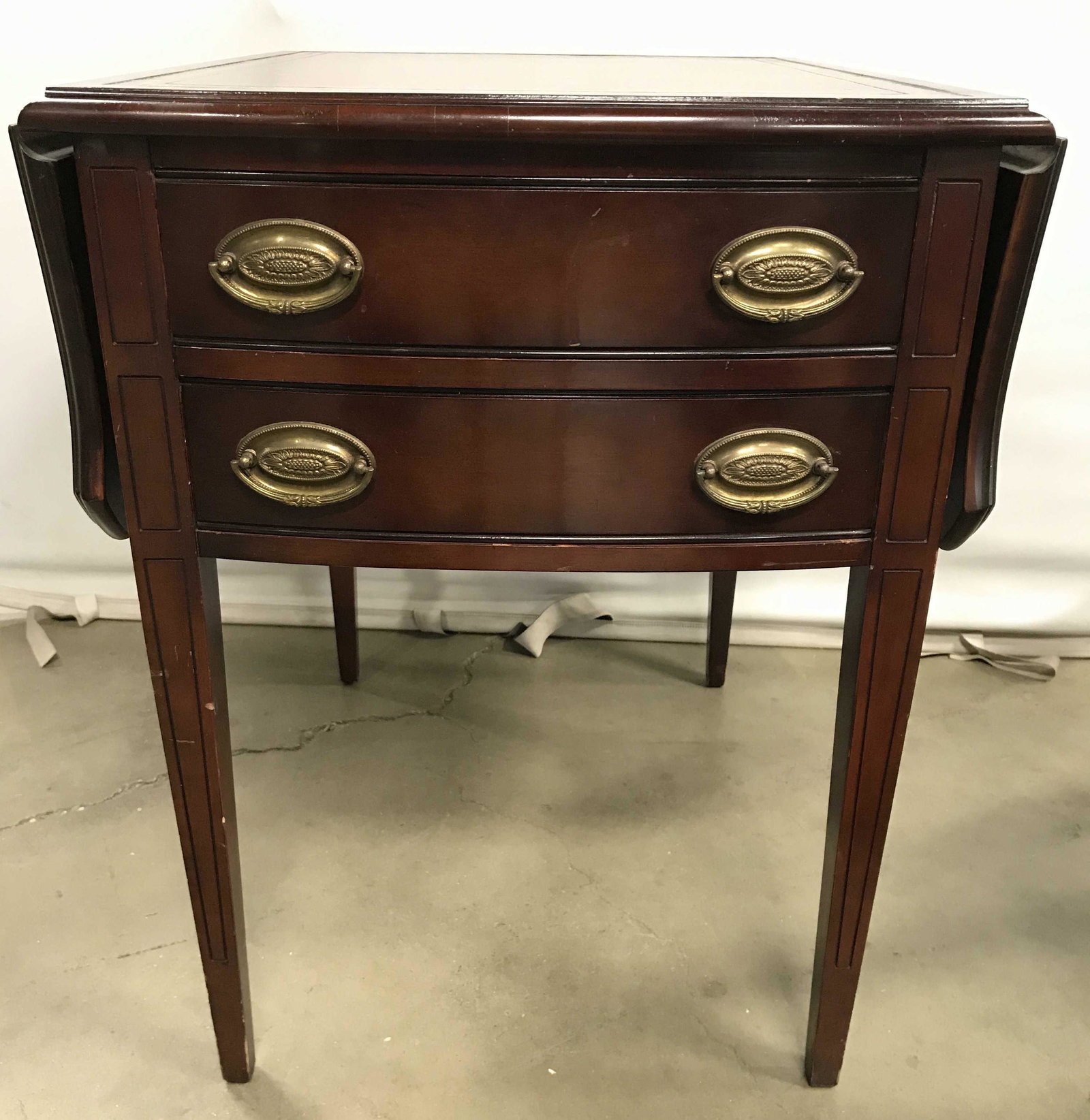 ZANGERLE Leather Top Drop Leaf Side Table: Underside has tag which reads ZANGERLE TABLES. Side table has leather top. Piece appears to possibly be mahogany. Measures approx 26.5 inches H, 20 inches W, 25.75 inches deep, 39.5 inches W with leav
