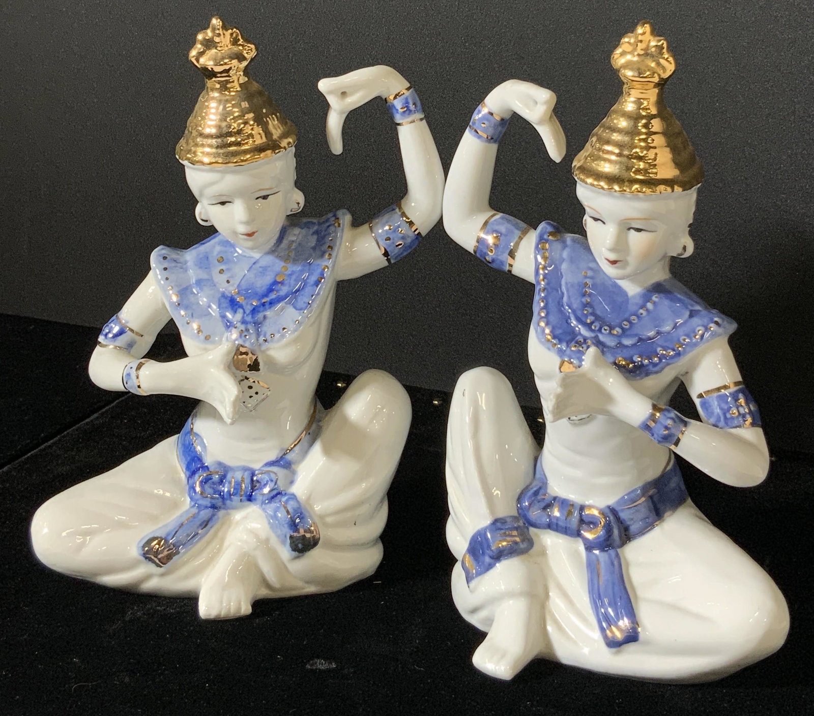 Pair Vintage Asian Porcelain Temple Dancer Figural: Set 2 Vintage porcelain temple dancer figurals. Made in China. Hand painted blue and gold tones, white porcelain. Striking traditional pose with one arm in air, bent. Signed underside reads: Chinese c