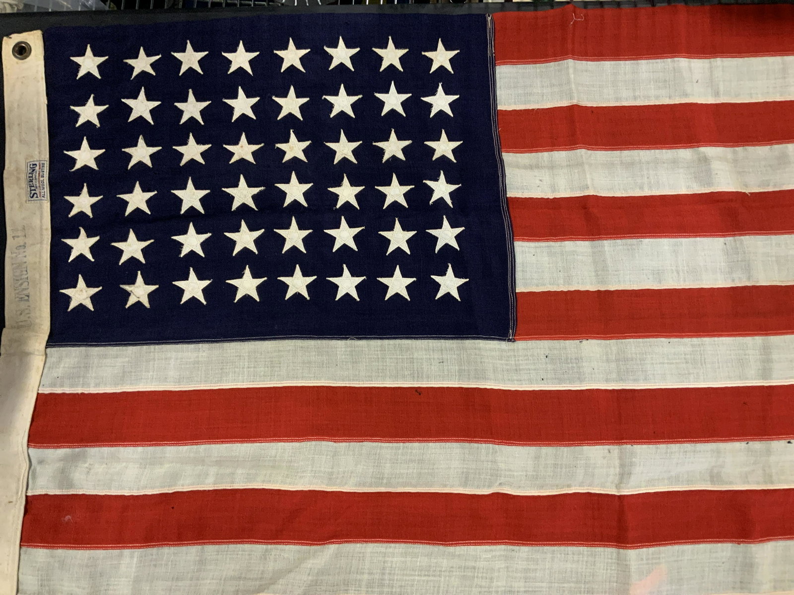 Vintage STERLING American Flag, 48 stars: Vintage STERLING American Flag, label reads ‘Sterling Reg US Pat Off Fast Color Double Warp All Wool Bunting’ and US Ensign No 11’, measures 28 5/8 x 54 1/2 inches, some holes to fabric but over