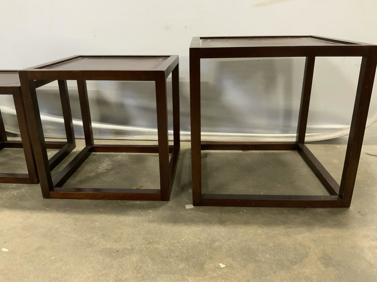 Set 4 Wooden Nesting Tables, Indonesia: Set of 4 wooden nesting tables. Label on underside reads as MADE IN INDONESIA. Largest measures approx 15 inches H, 15 inches W, 15 inches deep. Wear is consistent with age and use. Tables, carved woo