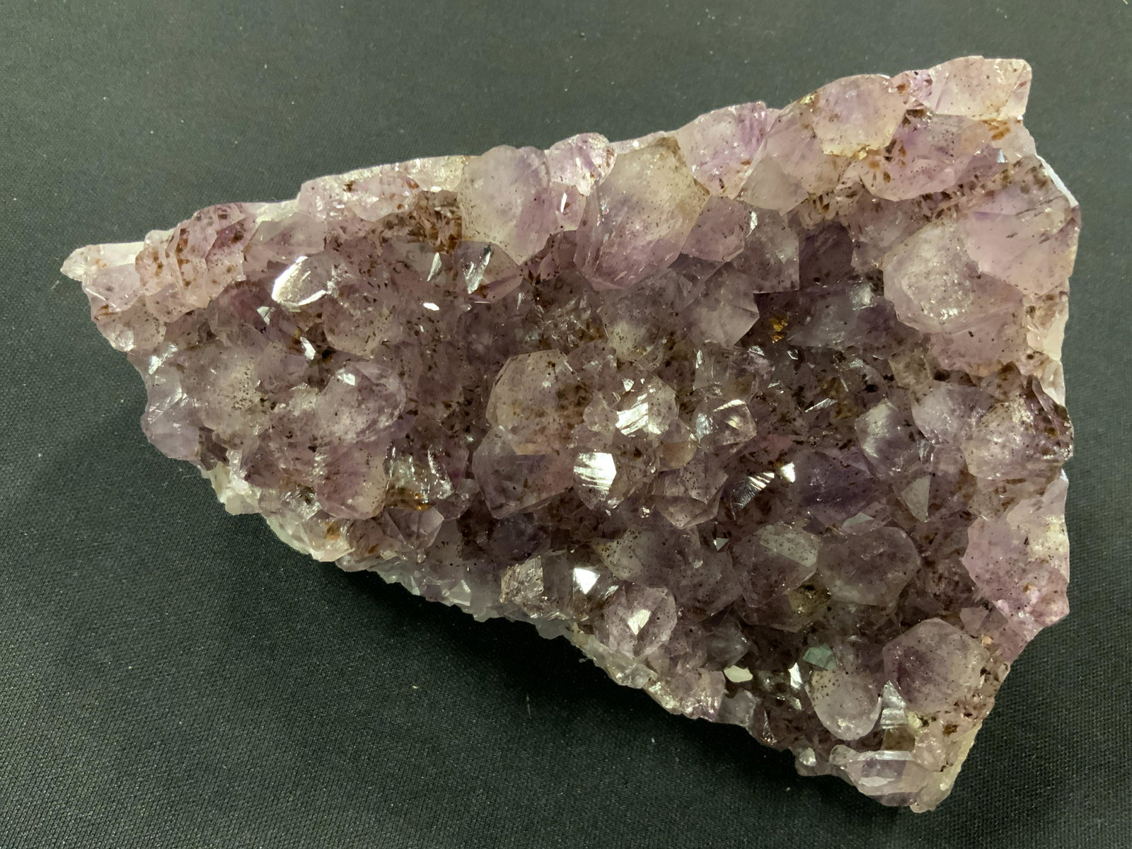 CURATED KRAVET New Large Purple Quartz Geode: New and packaged merchandise donated by Curated Kravet, lot includes a large purple Quartz crystal geode, item has thick layers of white and gray blue to the sides, items new in wrapping, perfect for 
