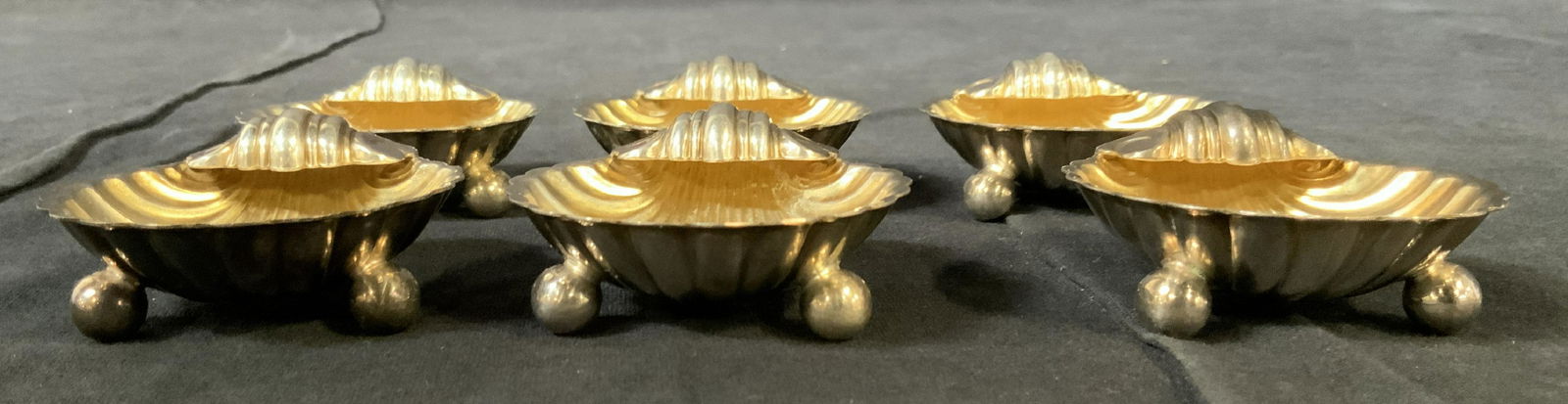 Set 6 REGIS ENGLAND EPC Silver Plated Salt Cellars: Set 6 REGIS ENGLAND EPC Silver Plated Salt Cellars, inscription to base reads ‘Regis England EPC’, all measure 5/8 inches tall x 2 1/4 inches at widest point, some surface wear but overall in good