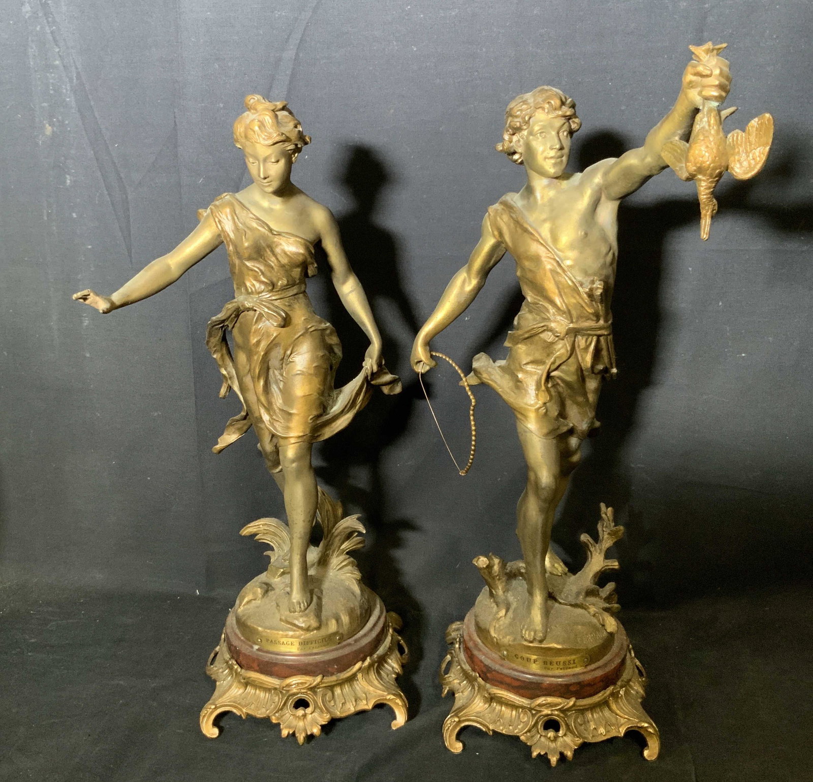 ERNEST J. FERRAND Signed Painted Metal Statues: Ernest Justin Ferrand signed painted white metal statues, signature to the base of both reads ‘Ferrand’, plaques to each read ‘Passage Difficile Par Ferrand’ and ‘Coup Reussi Par Ferrand’,