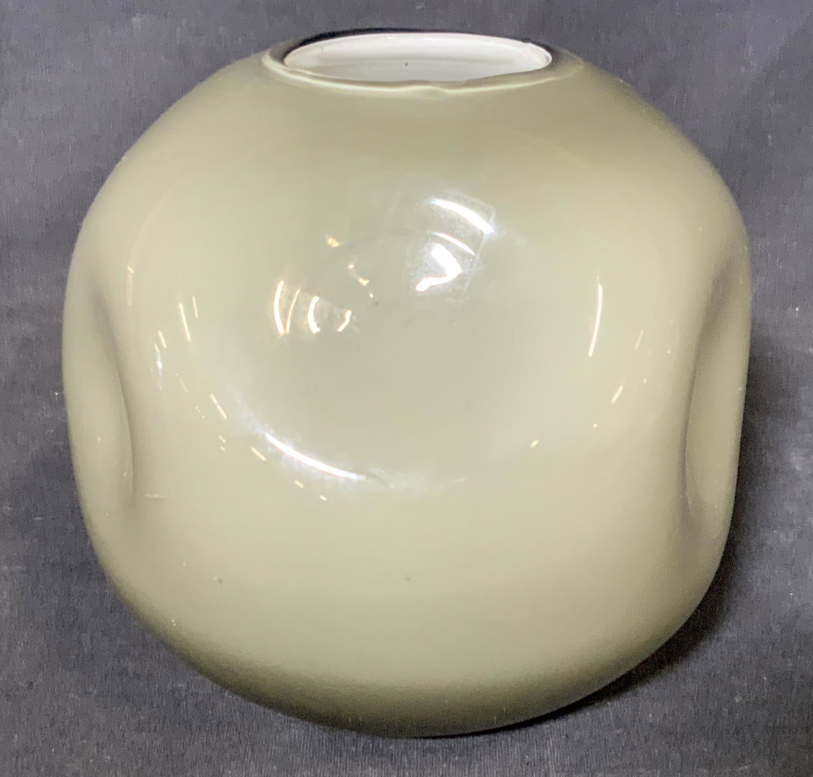 Grey Abstract Art Glass Vase: Grey abstract art glass pot, no apparent inscriptions or signatures, subject a semi round pot with 6 indentations to the sides, outer layer of glass to pot is a translucent black while the interior la