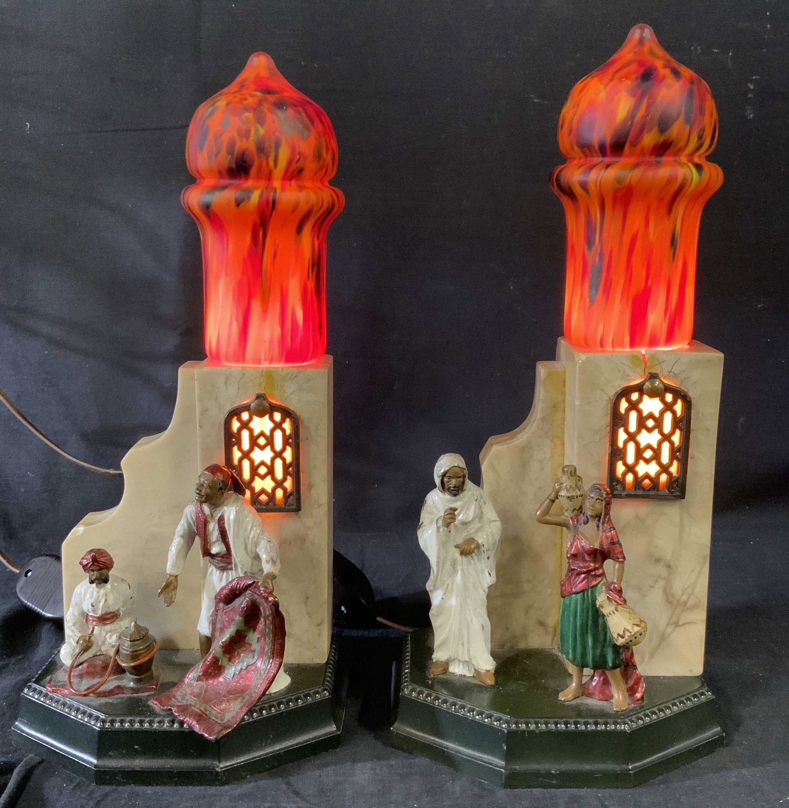 Pair Middle Eastern Style Table Lamps, Germany: Pair Middle Eastern Style Table Lamps, Germany, possible marble or alabaster base, inscription to base reads ‘Germany’, features figures engaged in various activities, one measures 11 7/8 x 5 1/2 