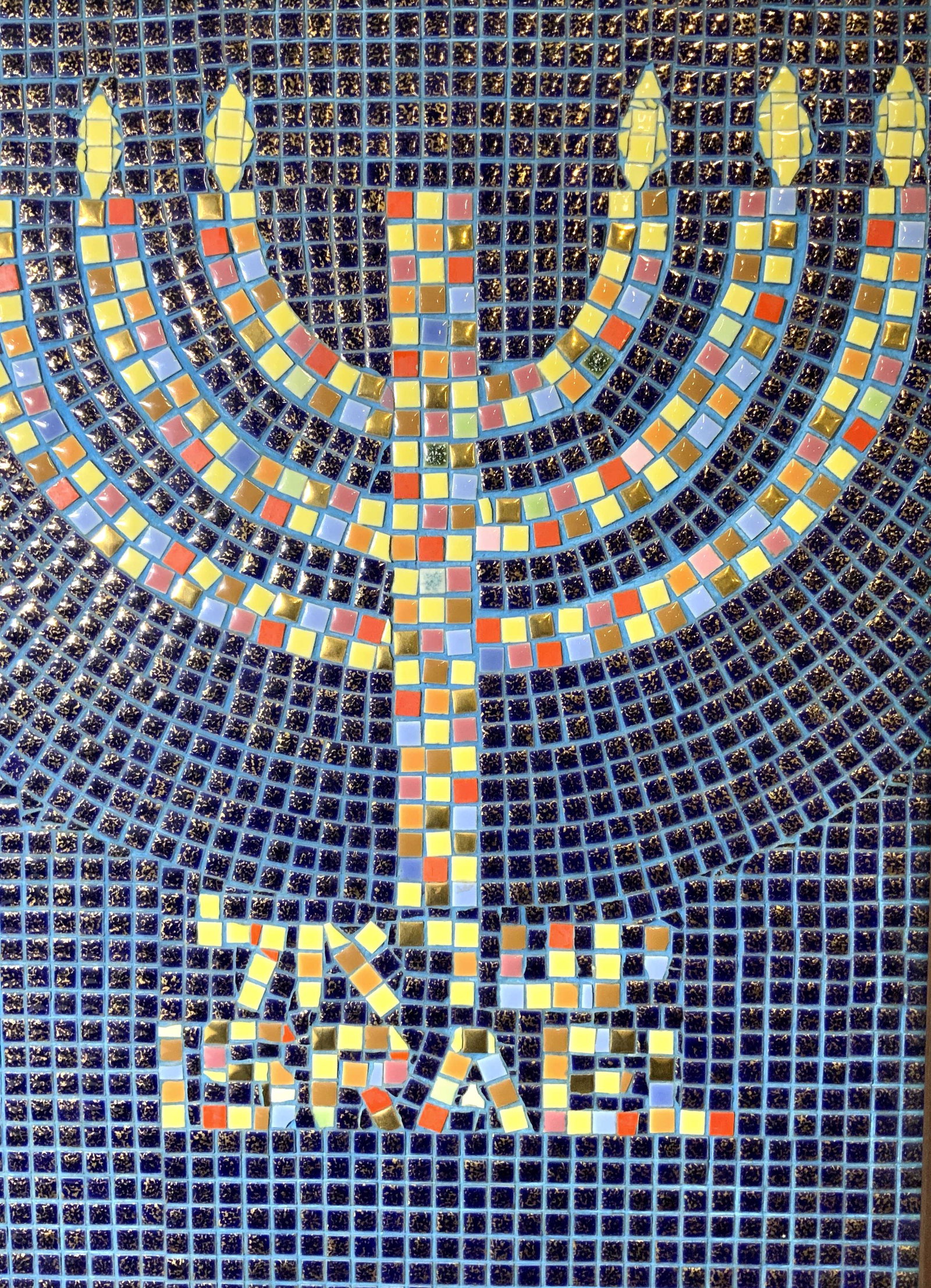7 Candle Menorah Framed Tile Mosaic: 7 candle menorah framed tile mosaic, no apparent inscriptions or labels, subject a 7 candle menorah with the word Israel and a word in Hebrew beneath it, words and menorah are made of bright colored a