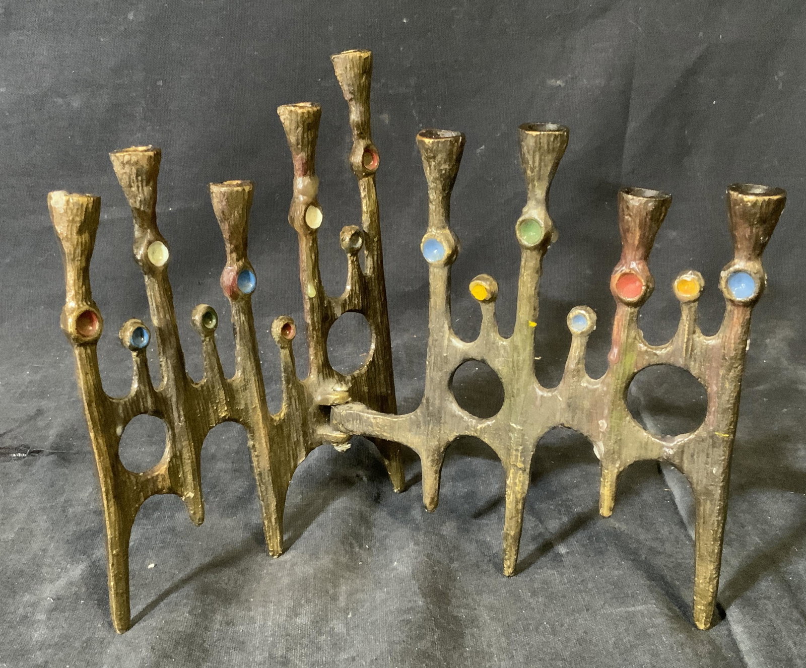 Signed Abstract Brutalist Israeli Menorah: Signed Abstract brutalist Israeli Menorah, inscription to reverse illegible, menorah in two pieces connected by a hinge allowing for the piece to unfold, piece has divots in it painted with various co