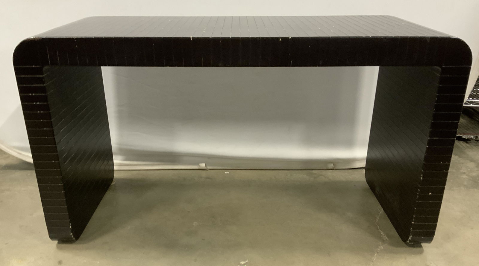 KARL SPRINGER Waterfall Desk CAFIERO STUDIOS: Leather bound, wooden waterfall desk. From CAFIERO STUDIOS, designed by KARL SPRINGER. Desk is mid century modern, and vintage. Measures approx 26.5 inches H, 48 inches W, and 20 inches deep. Wear is