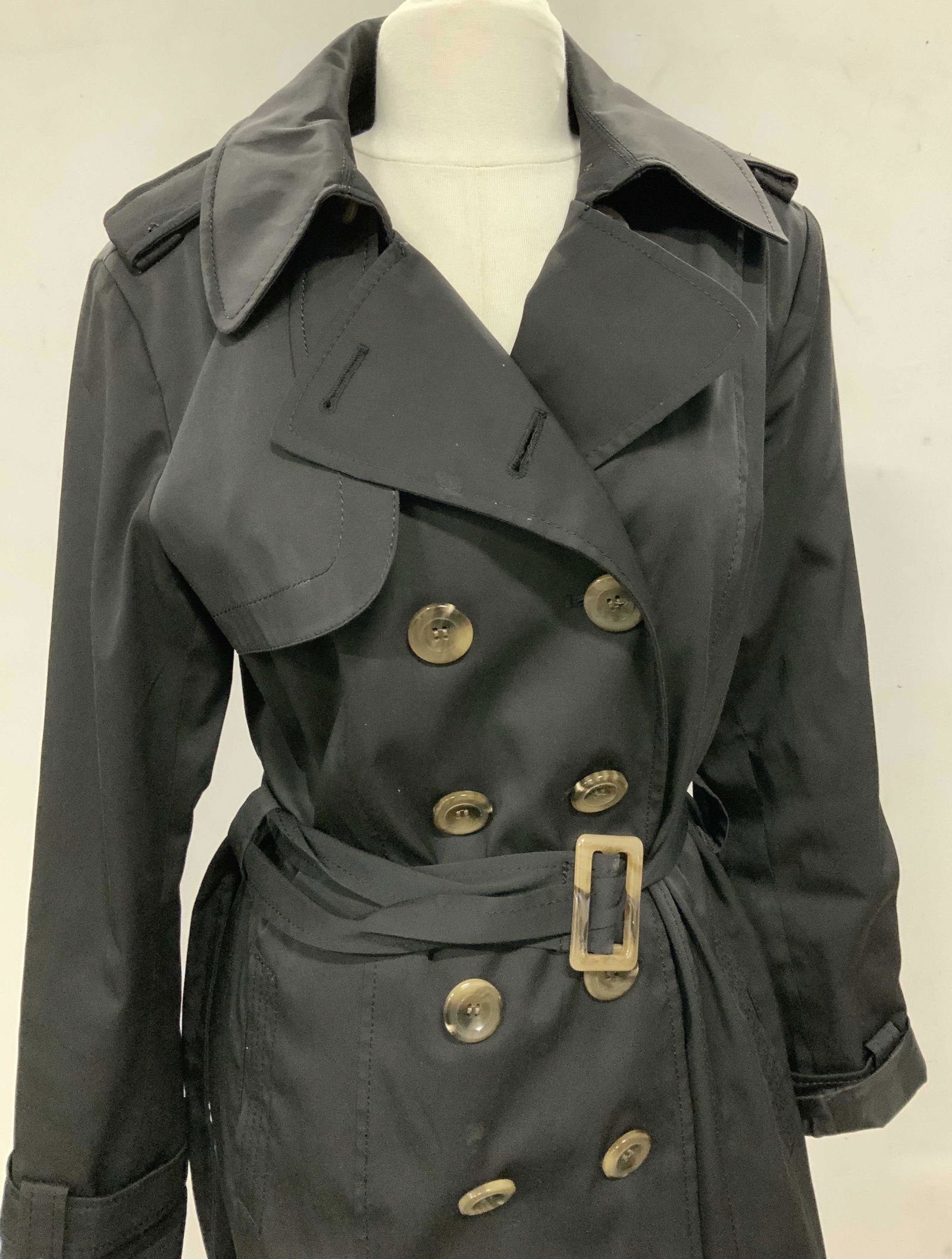 DONATELLA Signed Black Trench Coat, ladies: Multi weather trench coach by luxe designer DONATELLA. Size 12. Ext 55% polyester, 42% cotton 3% spandex. Lined with polyester. Designer label attached, comes with belt and extra buttons. Double breas