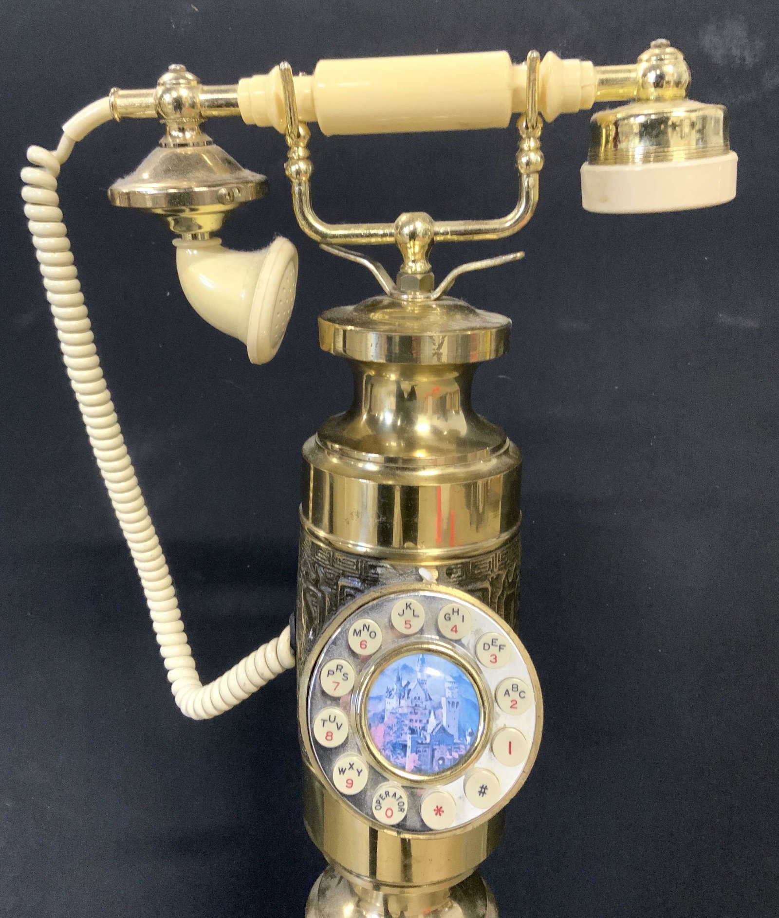 Vintage Brass Floor Size Telephone 41 in H: Telephone is floor size. Piece is gold toned & appears to be brass. Phone has circular dial pad. Handle, ear piece & mouth piece appear to be Bakelite. Vintage phone, floor size phone, brass phone, vi