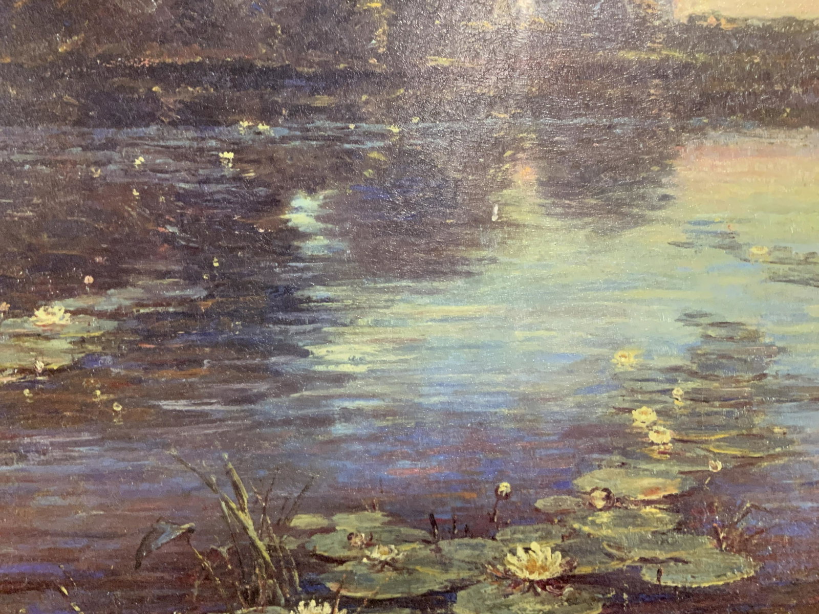 Monet Style Print Painting on Canvas in Gilt Frame: Monet style print painting on canvas in gilt frame, signature to the lower right corner illegibly written, subject a waterscape of a lake or pond with lily pads and lotuses floating on the surface, ha