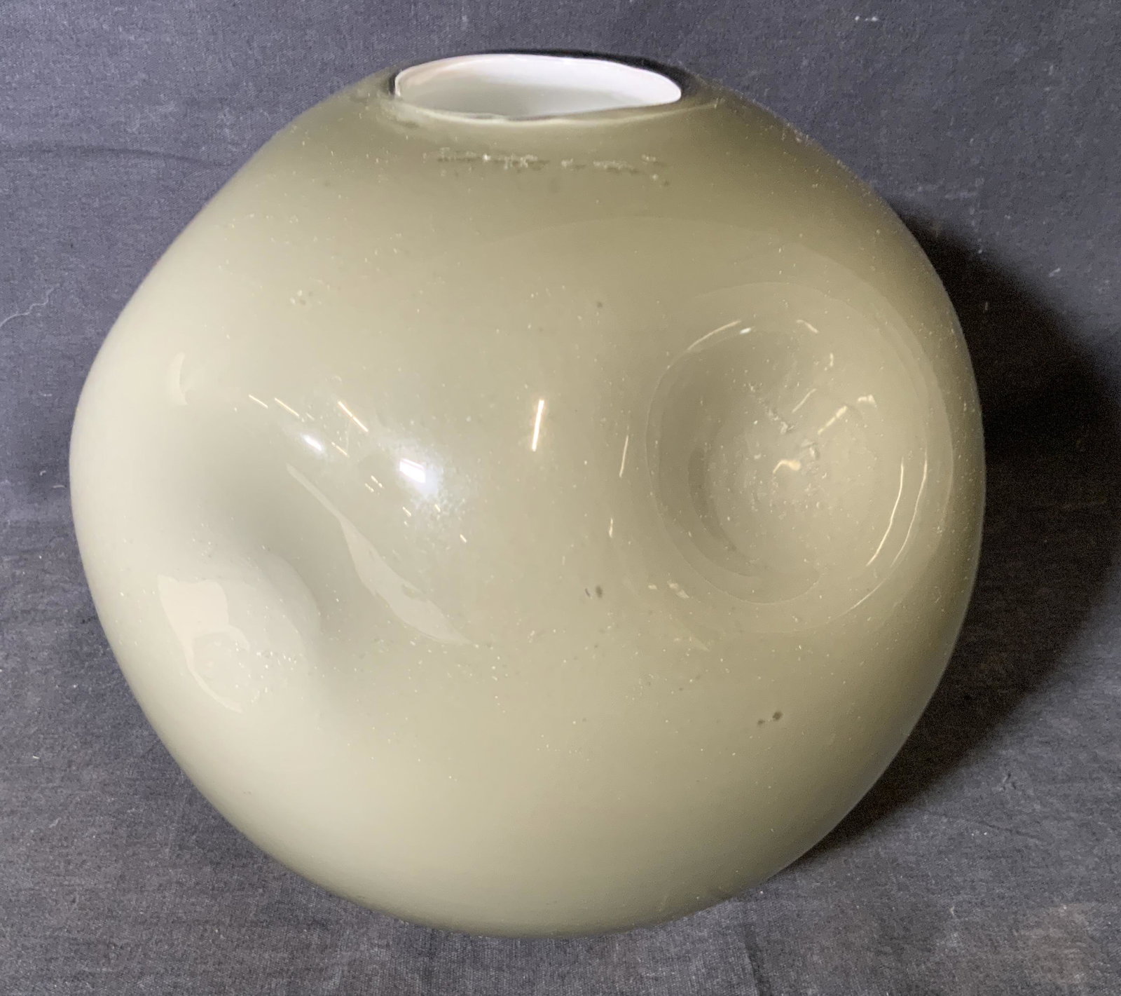 Grey Abstract Art Glass Vase: Grey abstract art glass pot, no apparent inscriptions or signatures, subject a semi round pot with 6 indentations to the sides, outer layer of glass to pot is a translucent black while the interior la
