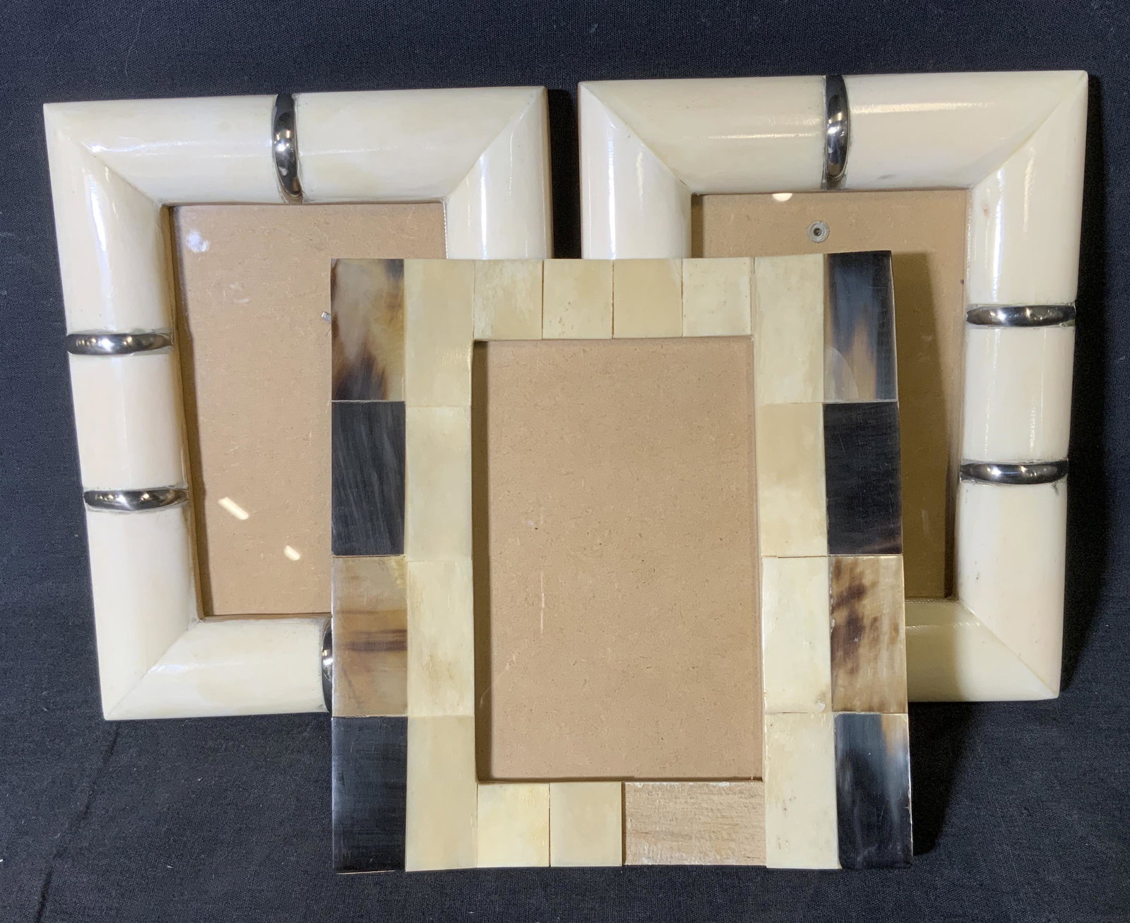 Group Lot 3 Composite Shell Picture Frames: Group lot 3 composite shell picture frames, two of three are made of a white composite with silver toned metal accents and rounded edges, these two hold a picture measuring 3.5 x 5.5, third frame made