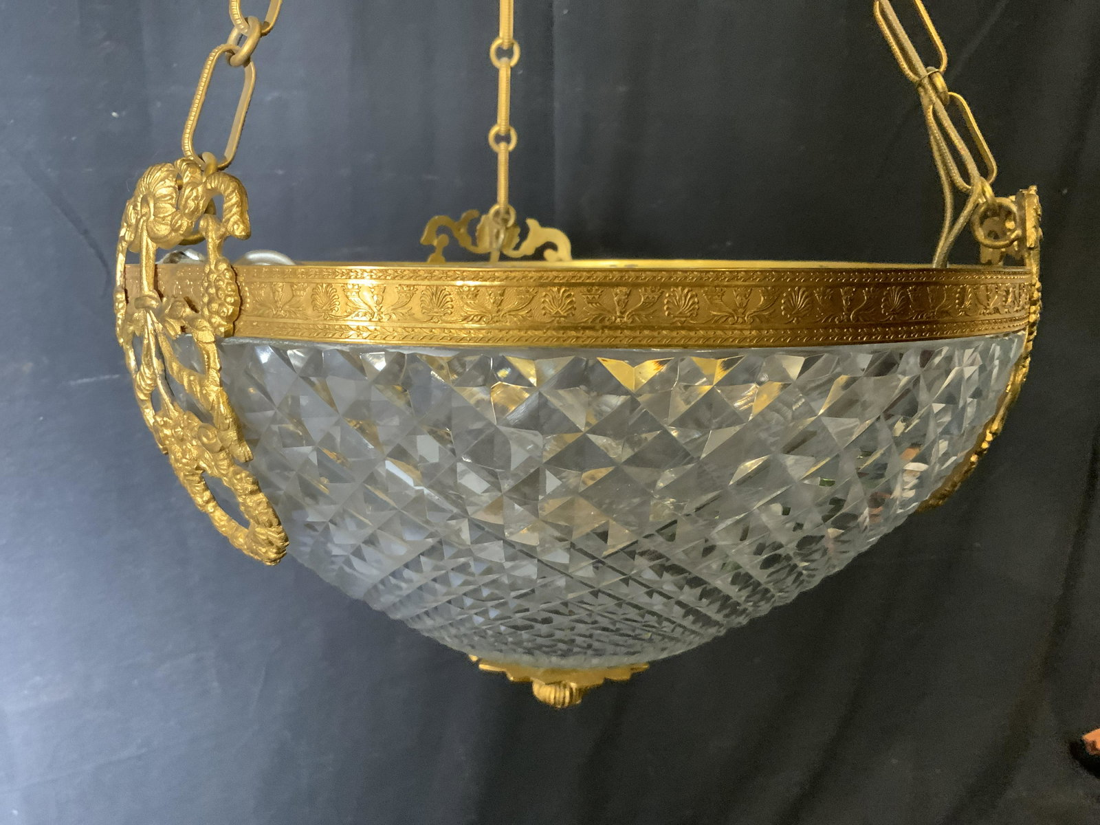 Glass Bowl Hanging Light Fixture: Glass bowl hanging light fixture, bowl of light fixture is patterned with a geometric pattern, piece has gold metal trimming and accents, piece hangs from three chains, needs to be electrified, piece 