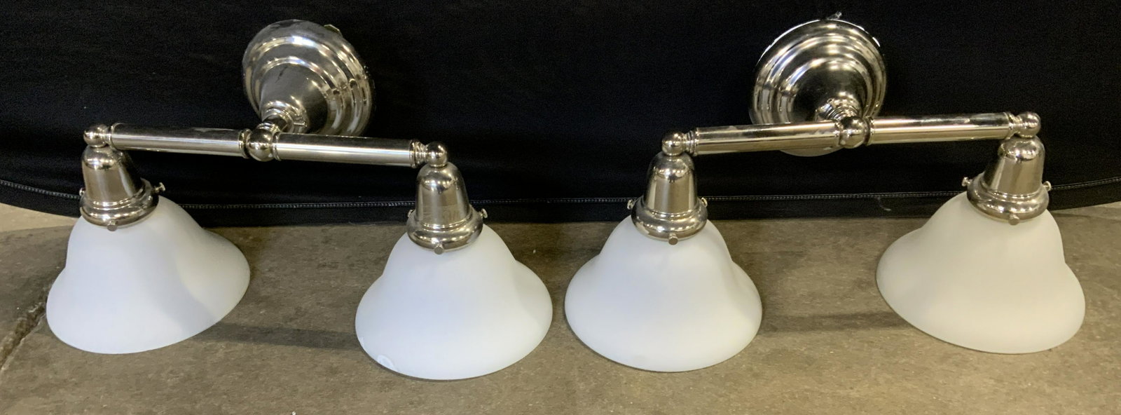 Pair Polished Metal Wall Sconces: Pair wall sconces, double socketed, frosted glass shades on each socket. Each measures approx 9 inches H, and 20 inches W. Wear is consistent with age and use. Lights, wall sconces, chrome, polished m