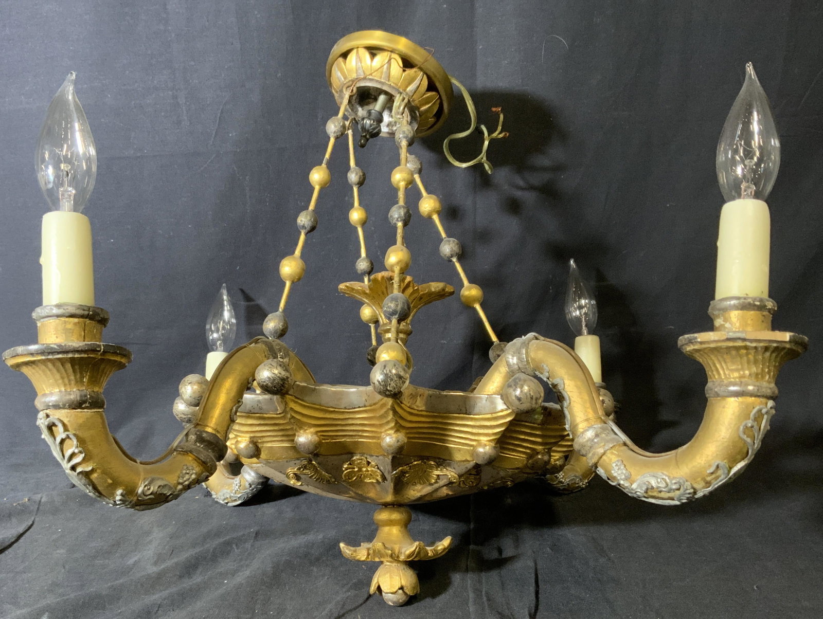 Vintage Venetian Style Chandelier: Vintage, possibly antique, Venetian style chandelier. Wood is hand painted, colored with gilt and silver paints. Each socket is coated with wax and resembles a candle. Measures approx 18 inches H, and