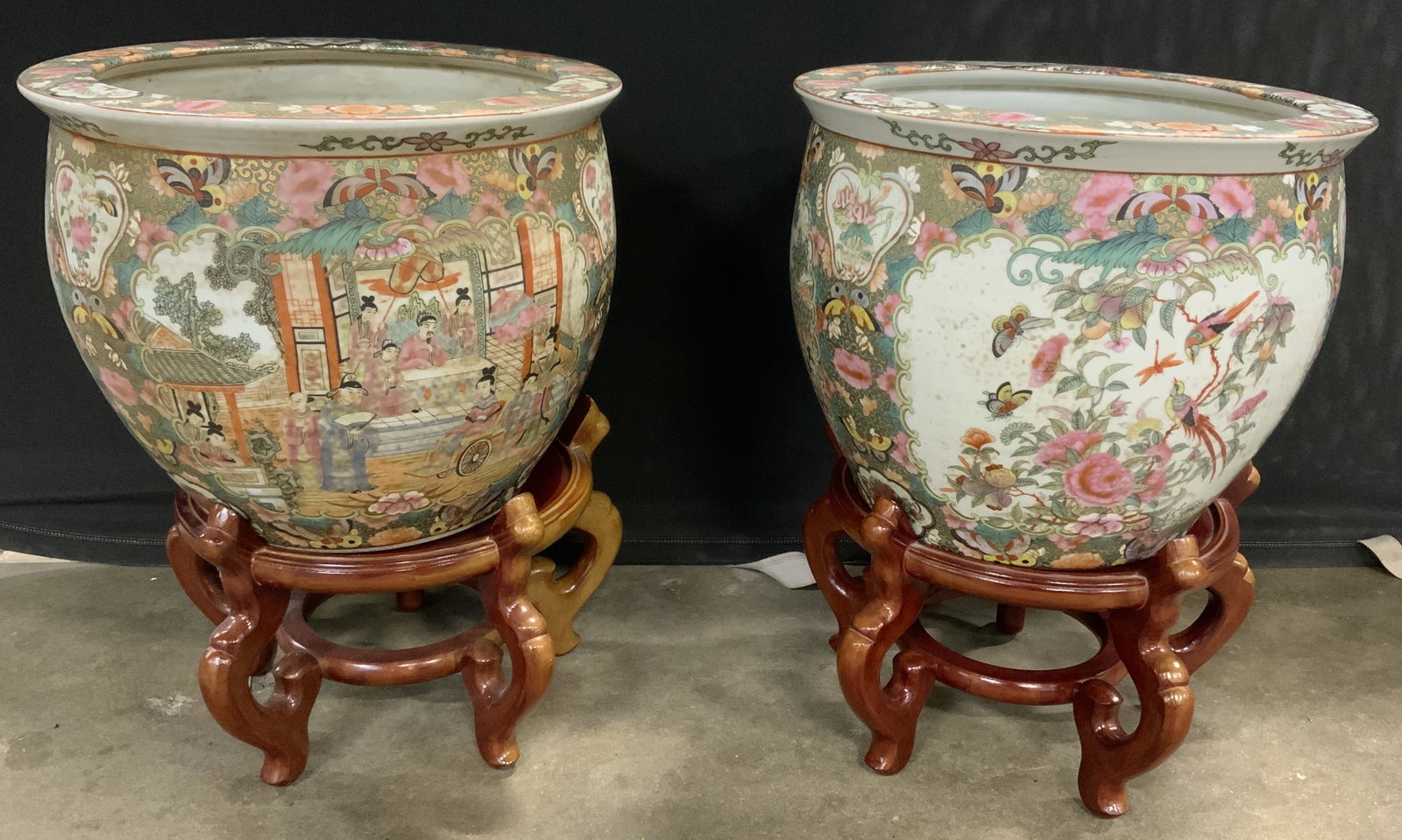 Pair Hand Painted Asian Planters w Stands: Pair of hand painted, vintage, Asian, ceramic planters. Paintings depict butterflies, potted plants, and people gathering. Interior paintings depicts gold fish among plants. Each planter measures appr