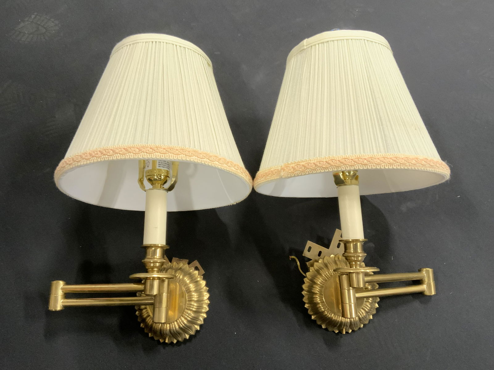 Pair Brass VAUGHAN Chedworth Swing Arm Wall Lights: Pair of brass swing arm wall lights. VAUGHAN chedworth light, crafted from brass, base is solid cast brass, resembles a plant. Finials are cut glass, lamp shade trim is braided. Each measures approx 1