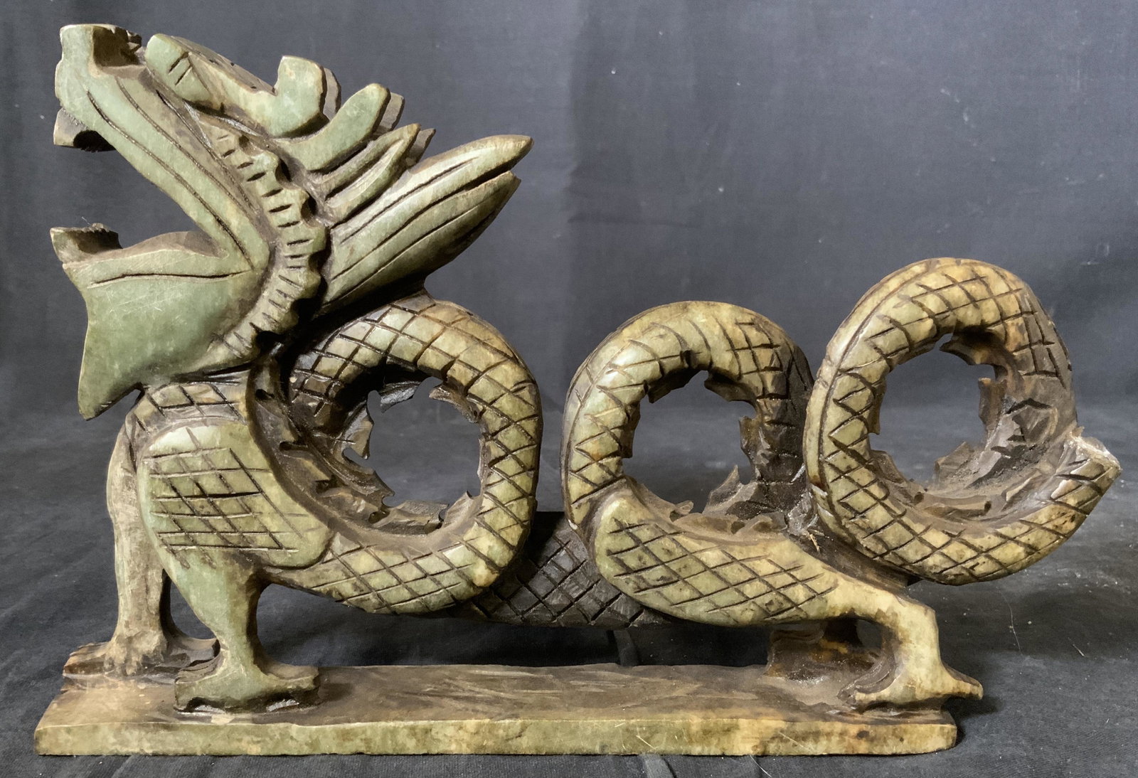 Vintage Chinese Jadeite Dragon Sculpture: Vintage possibly antqiue Chinese Jadeite Dragon Sculpture, no apparent inscriptions or marks, measures 6 5/8 x 10 inches at widest point, some surface wear and loss of tip of tail, Property of Manhatt